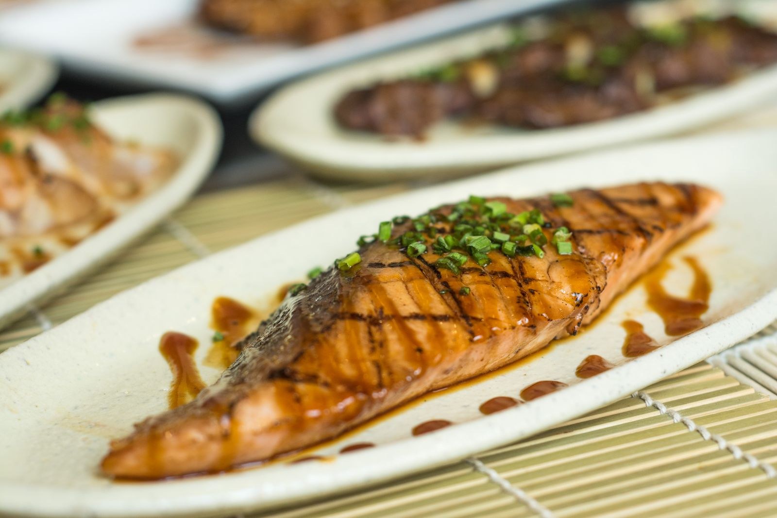 Apple cider dinners: glazed grilled salmon fillet on a white plate