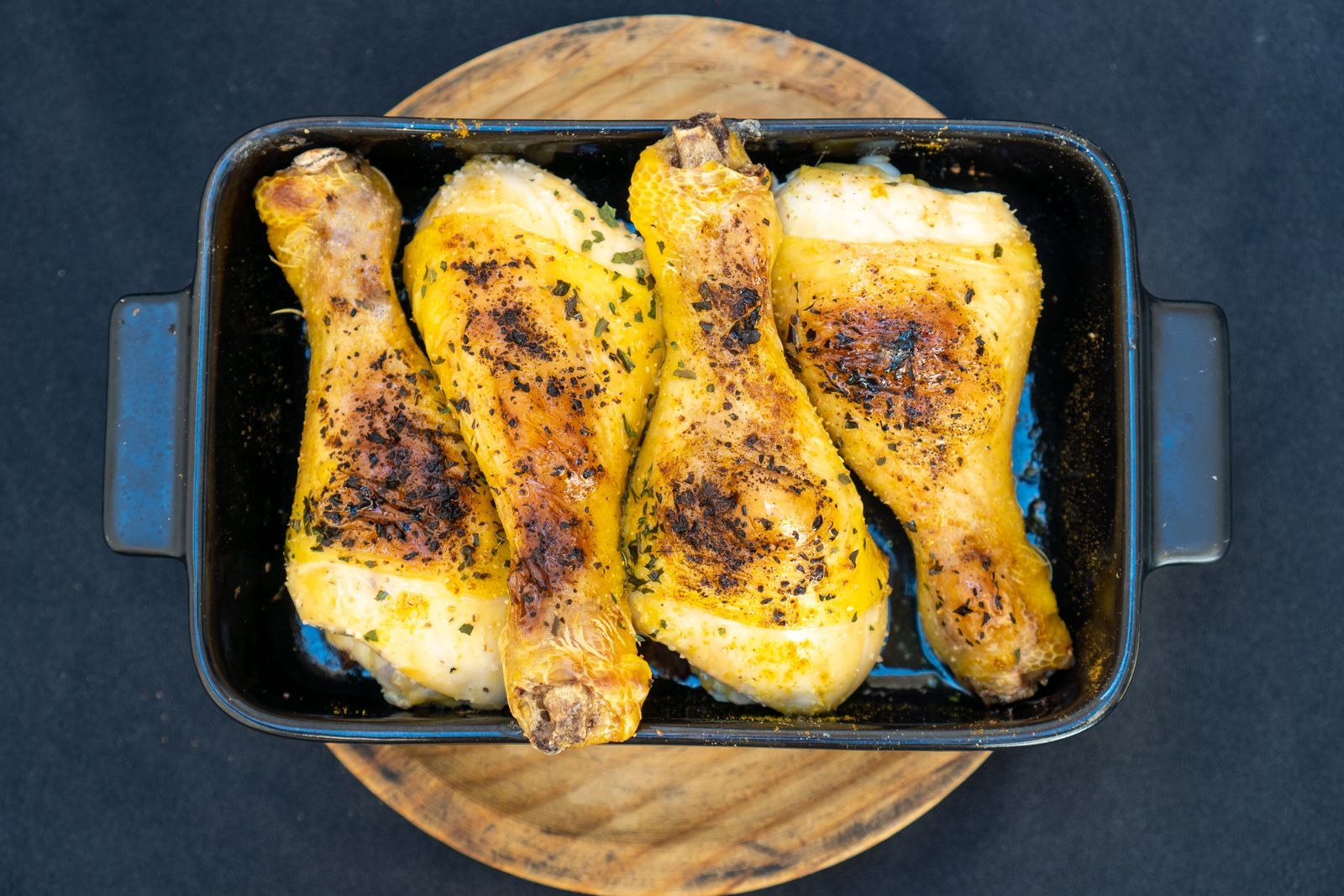 Apple cider dinners: roasted chicken drumsticks in a black baking tray