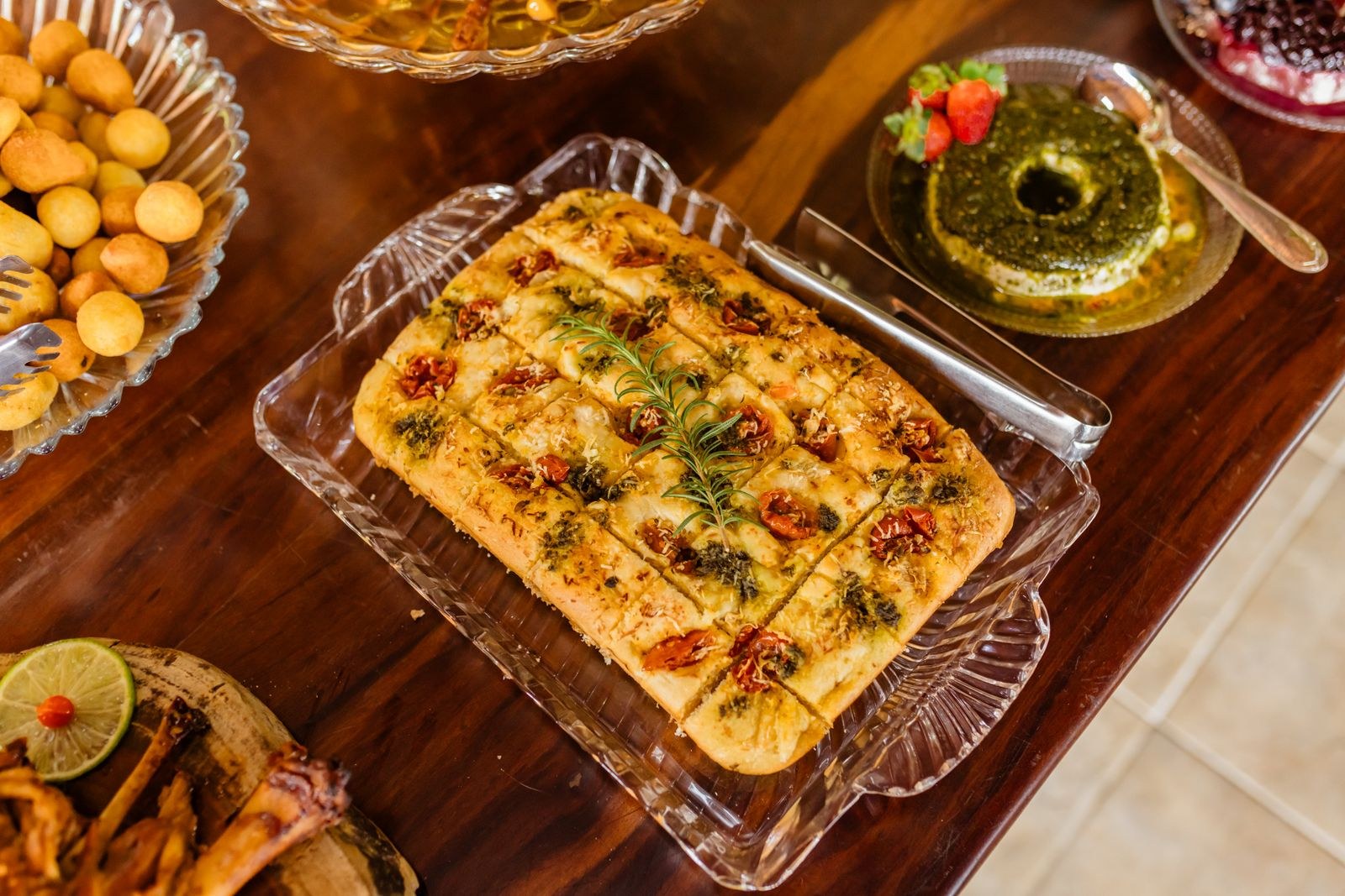 Golden baked bread with herbs in a glass dish