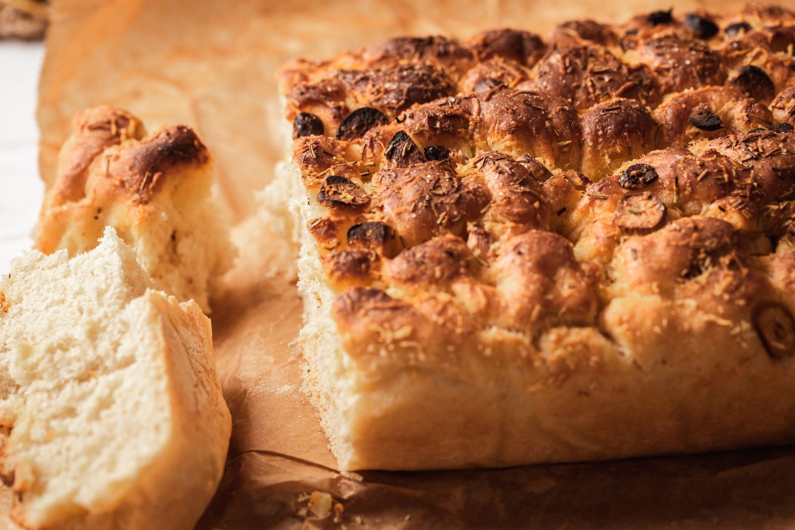 Golden crusty bread with a dimpled top, close up