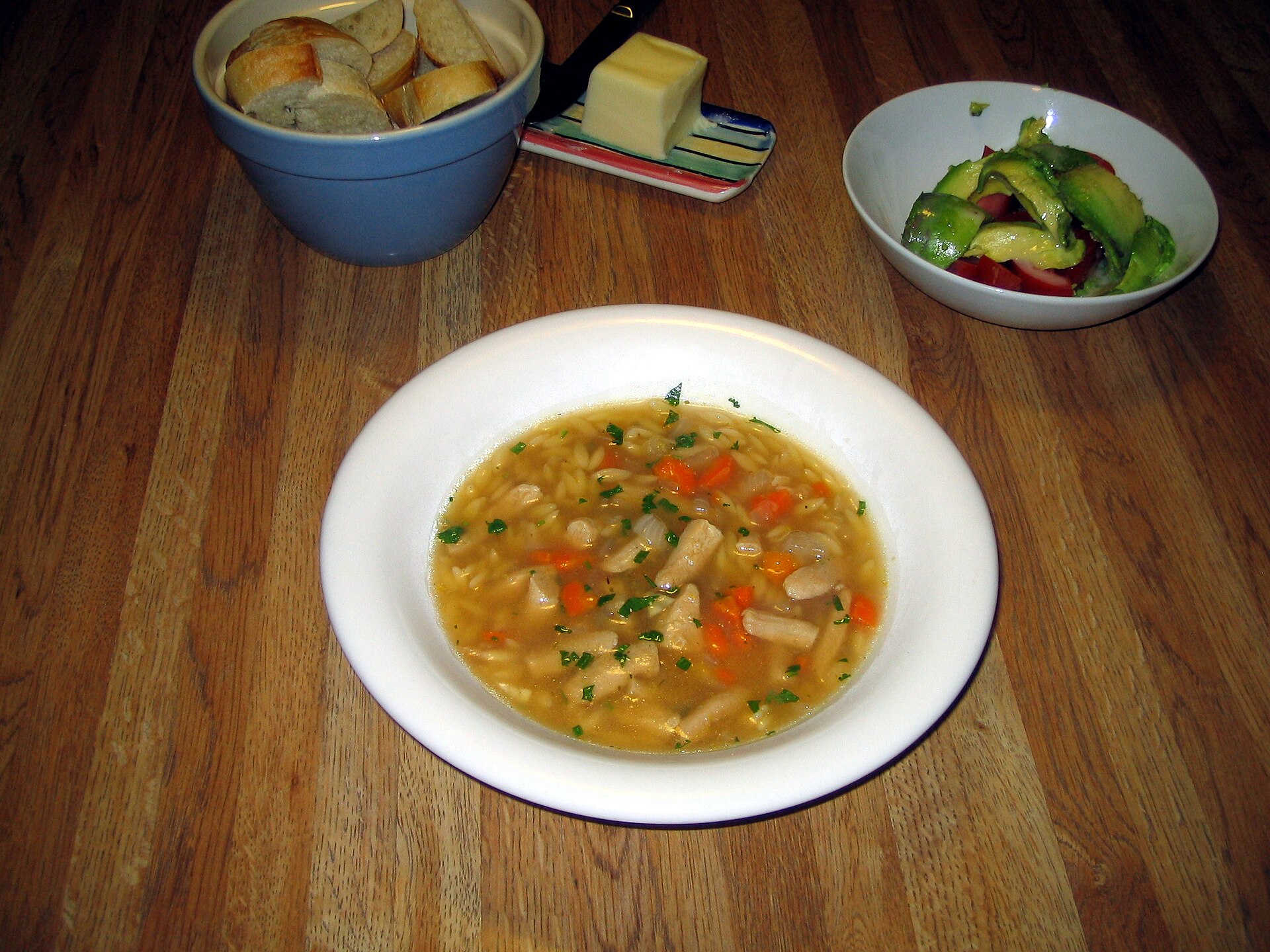 Bowl of lemon chicken orzo soup with carrots