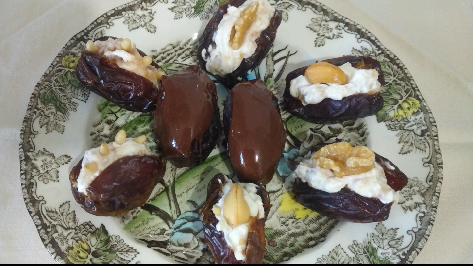 Spanish datiles rellenos, dates filled with cream cheese and nuts on a plate