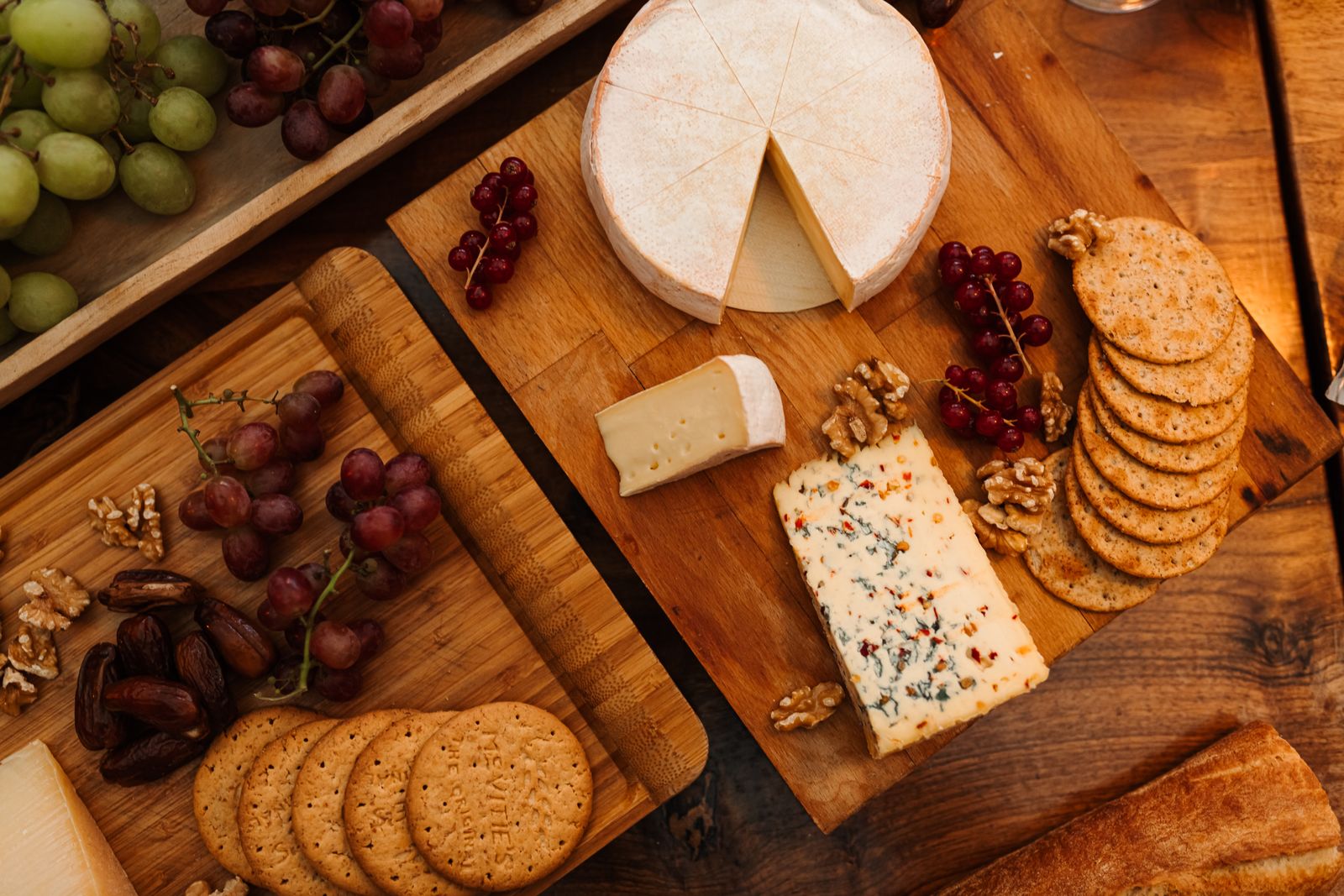 Cheese board with nuts, crackers and grapes for a party