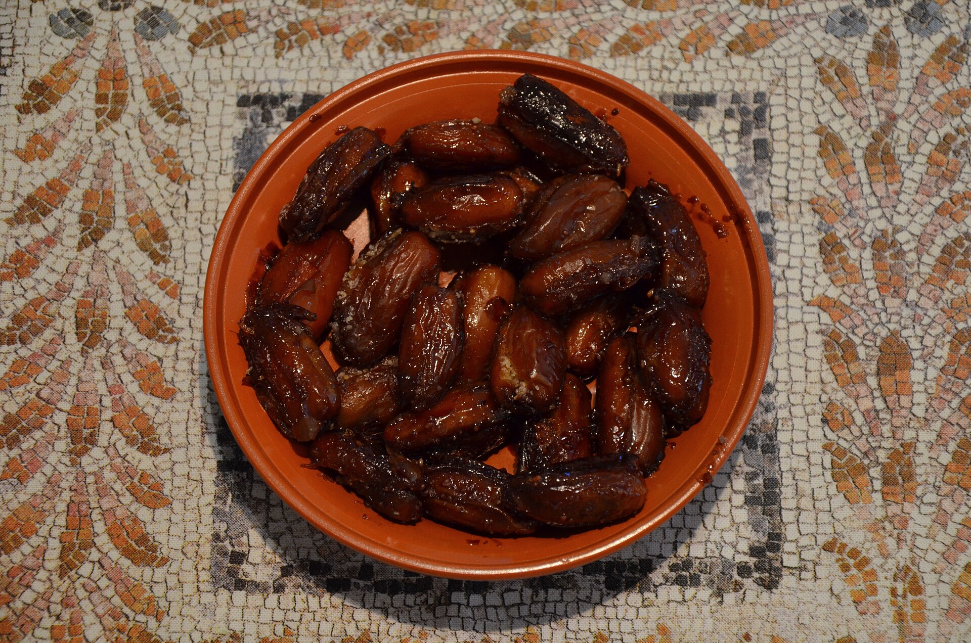 Dulcia domestica, ancient Roman stuffed dates in honey in a clay bowl