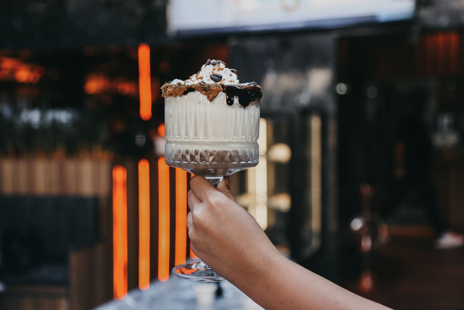 Cookies and cream milkshake with chocolate sauce and cookie crumbs