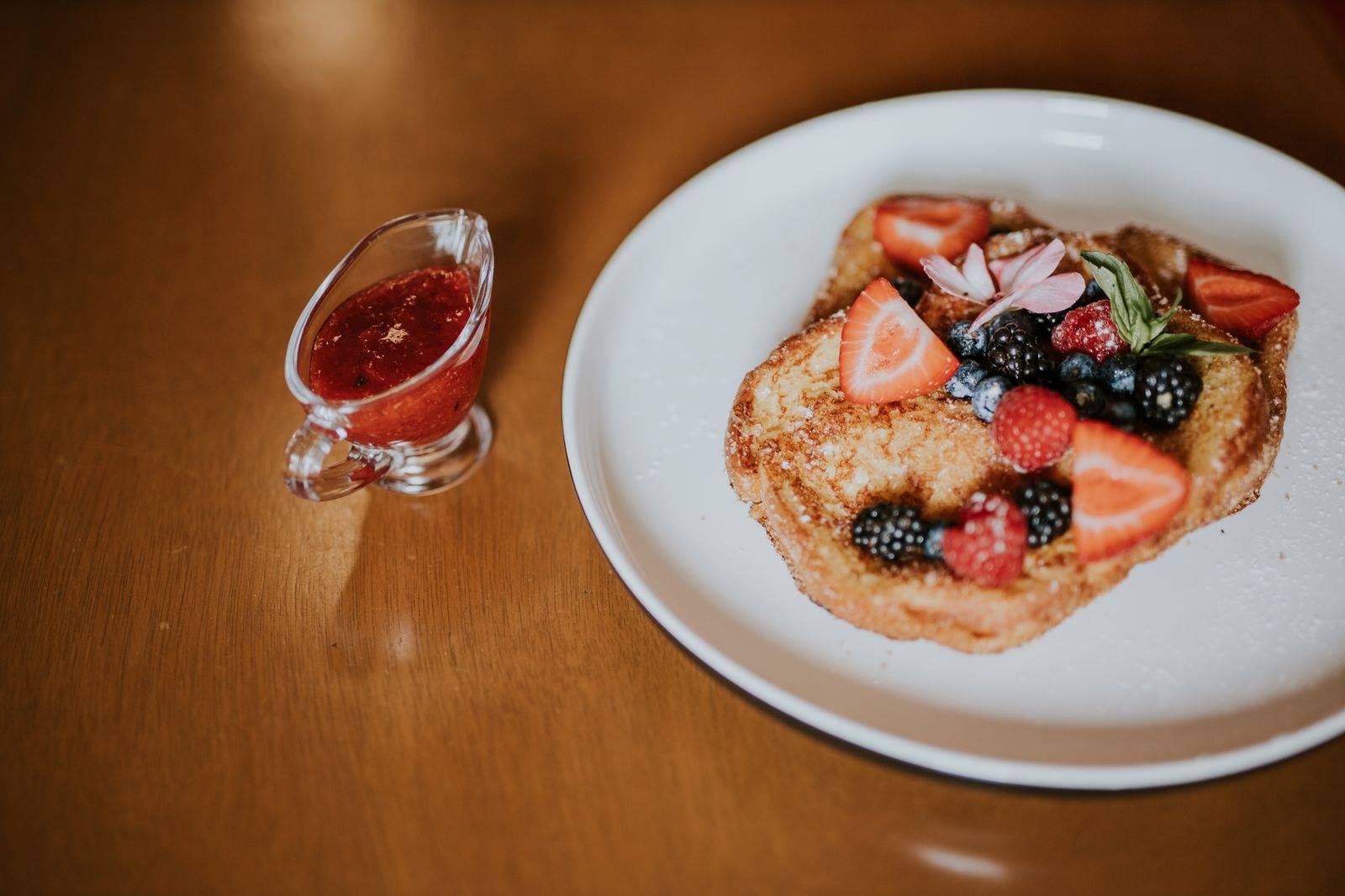 French toast topped with fresh berries and berry syrup