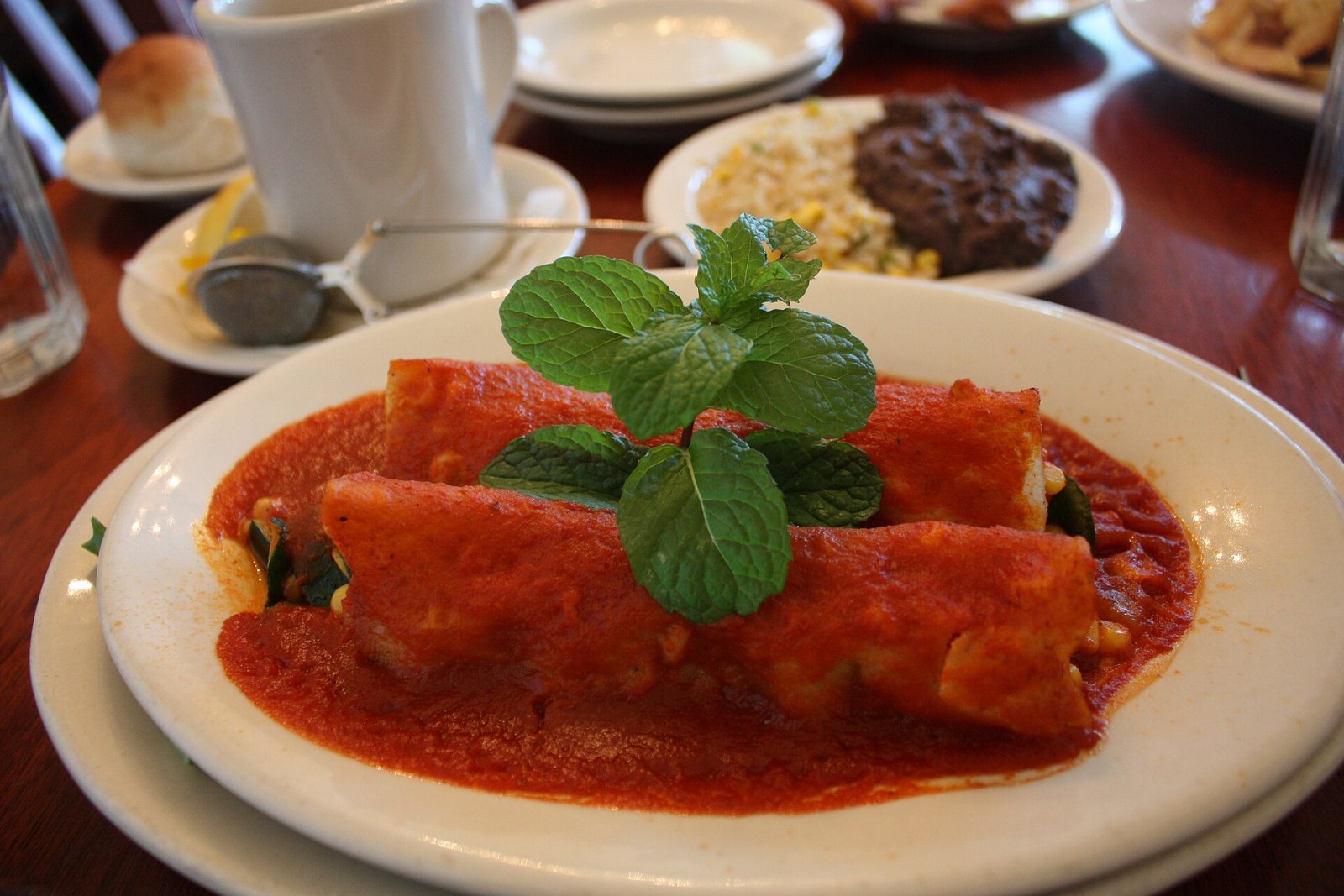 Enchiladas in red sauce topped with fresh cilantro