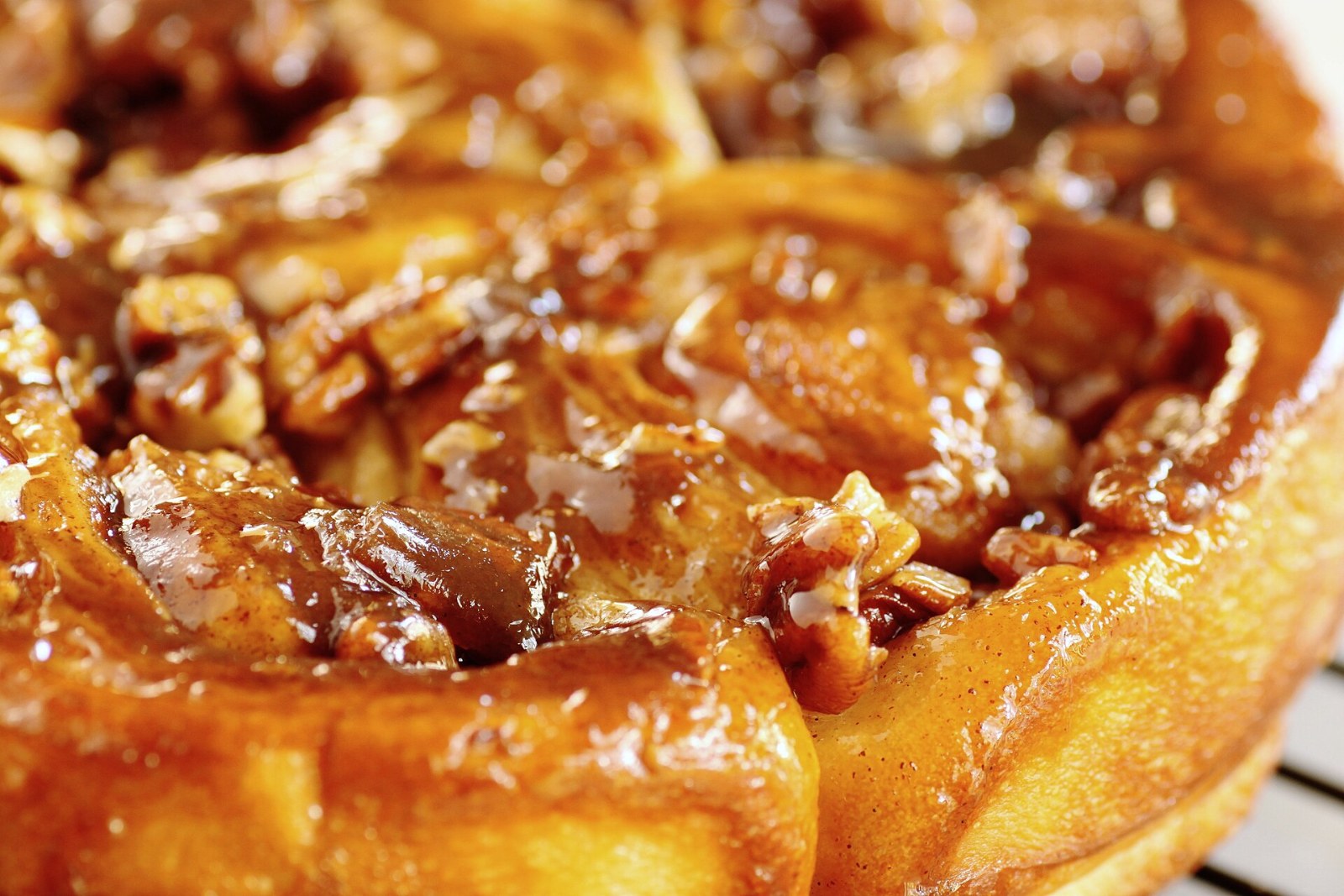 Caramel pecan sticky buns cooling on a wire rack