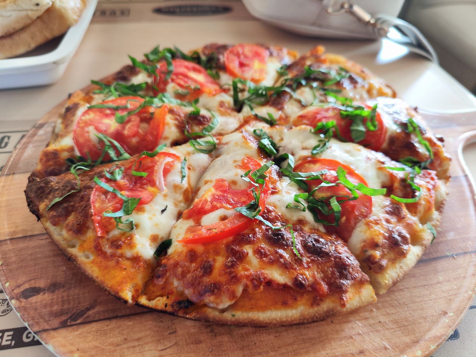 A margherita pizza with fresh basil and tomato