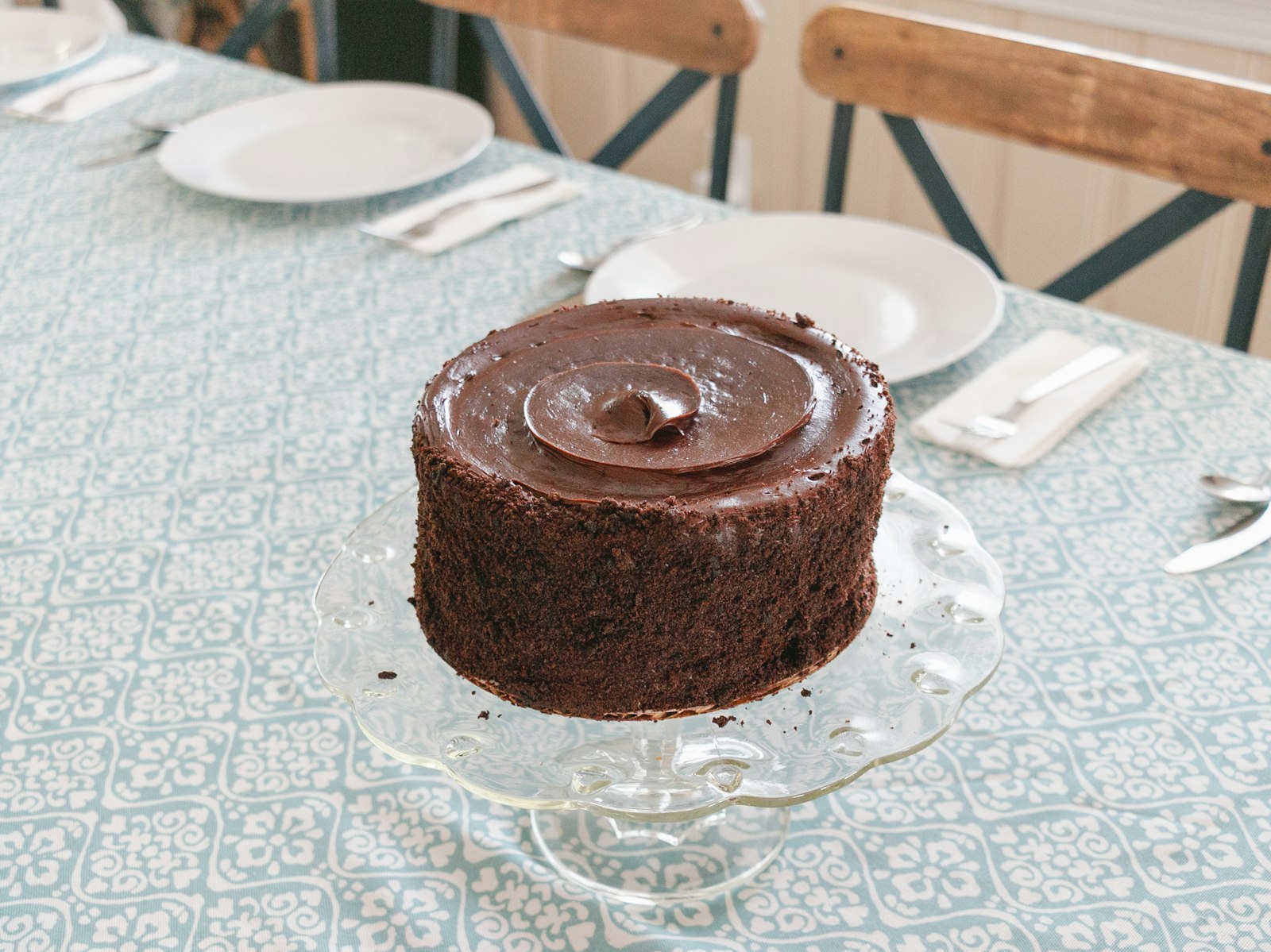 A small round flourless dessert with a glossy, dense top