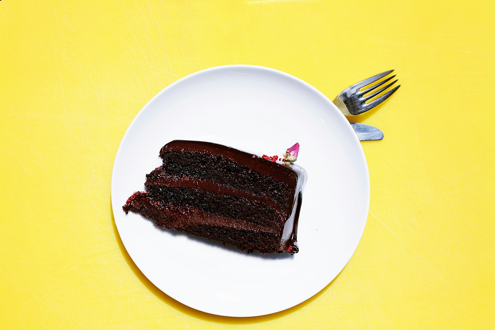 Chocolate cakes with a secret: a frosted layered slice on a white saucer