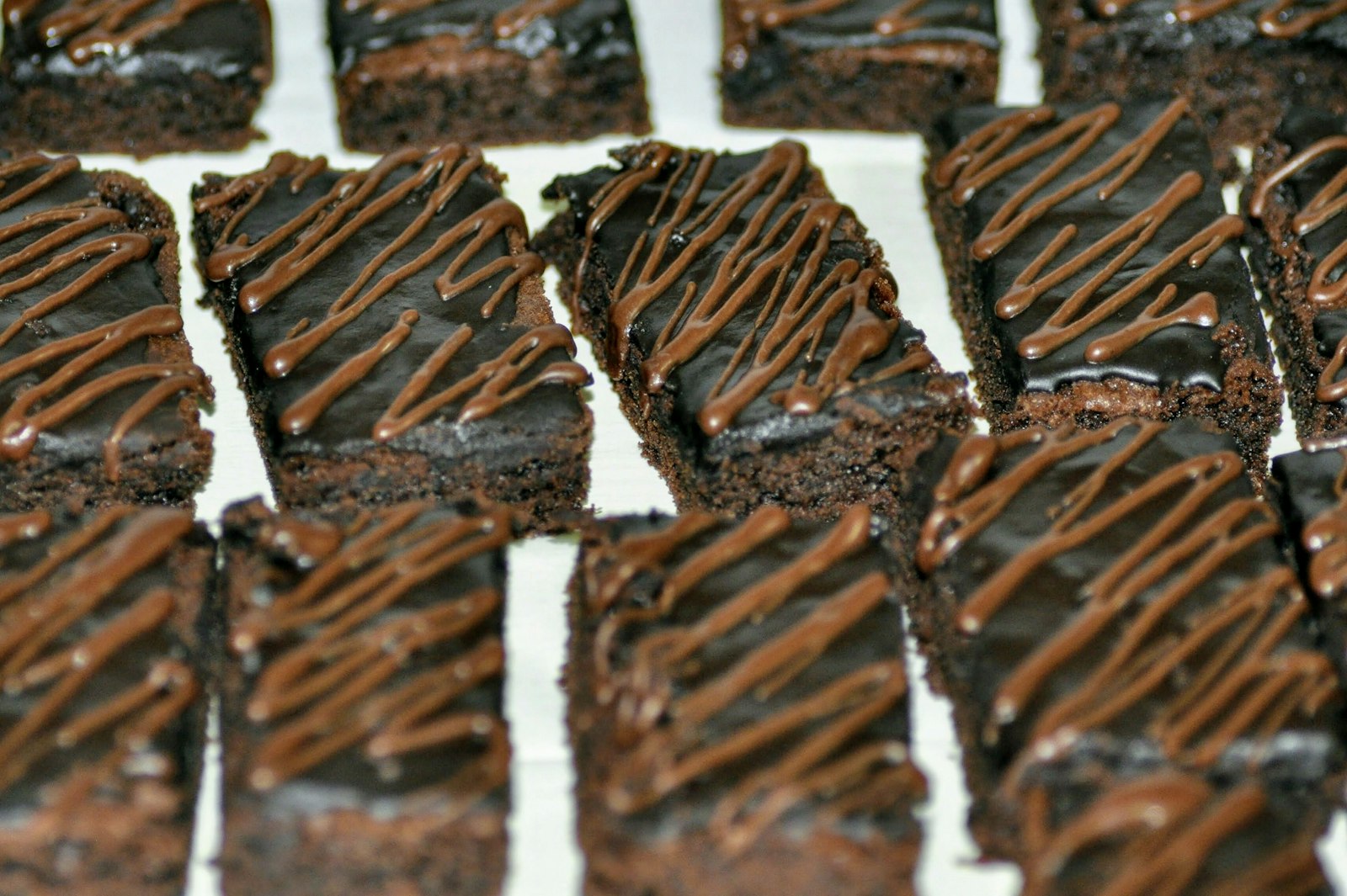 Thin squares with a glossy fudge topping, ready for a potluck