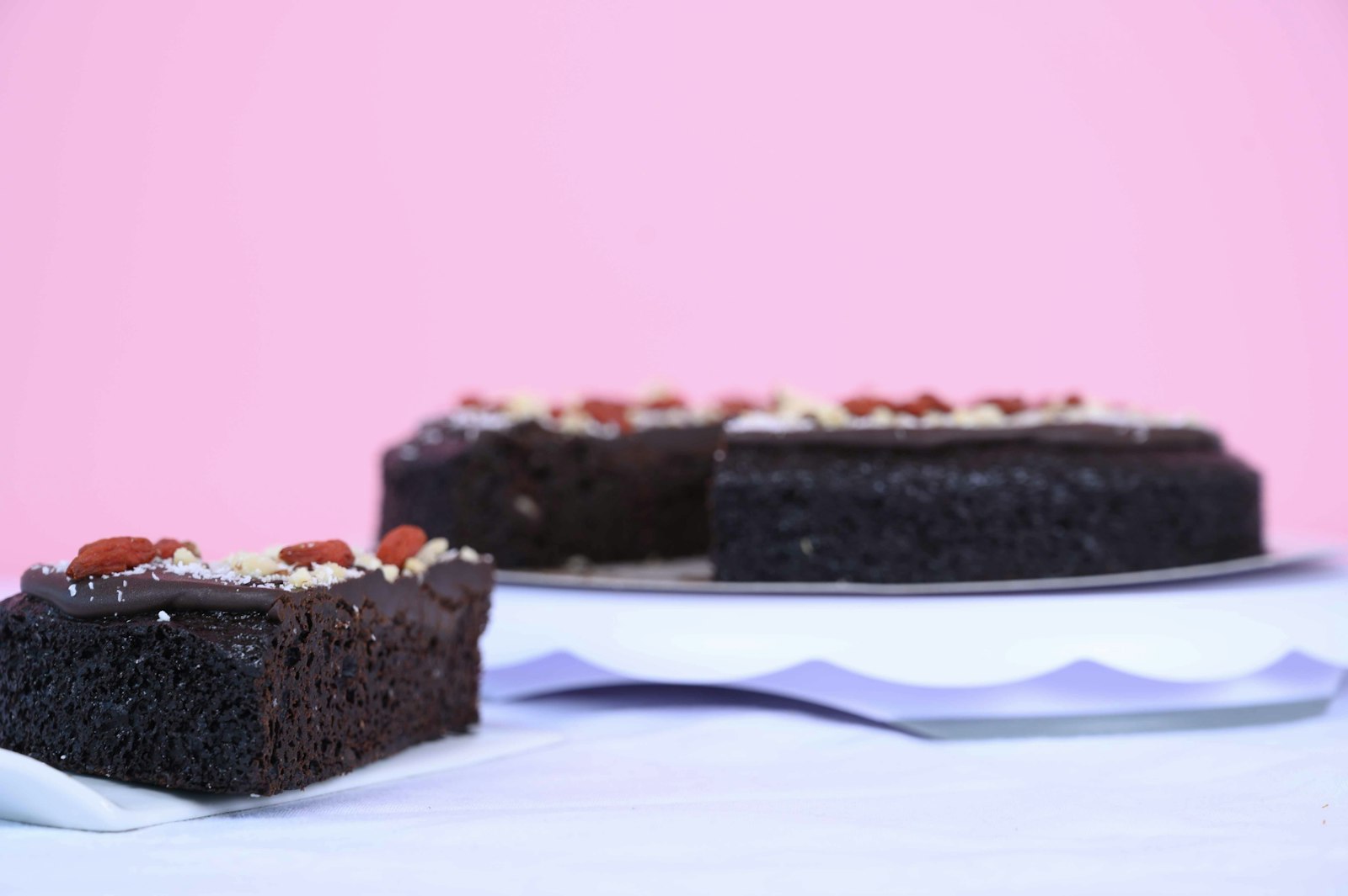 Squares of simple dark snacking dessert on white plates