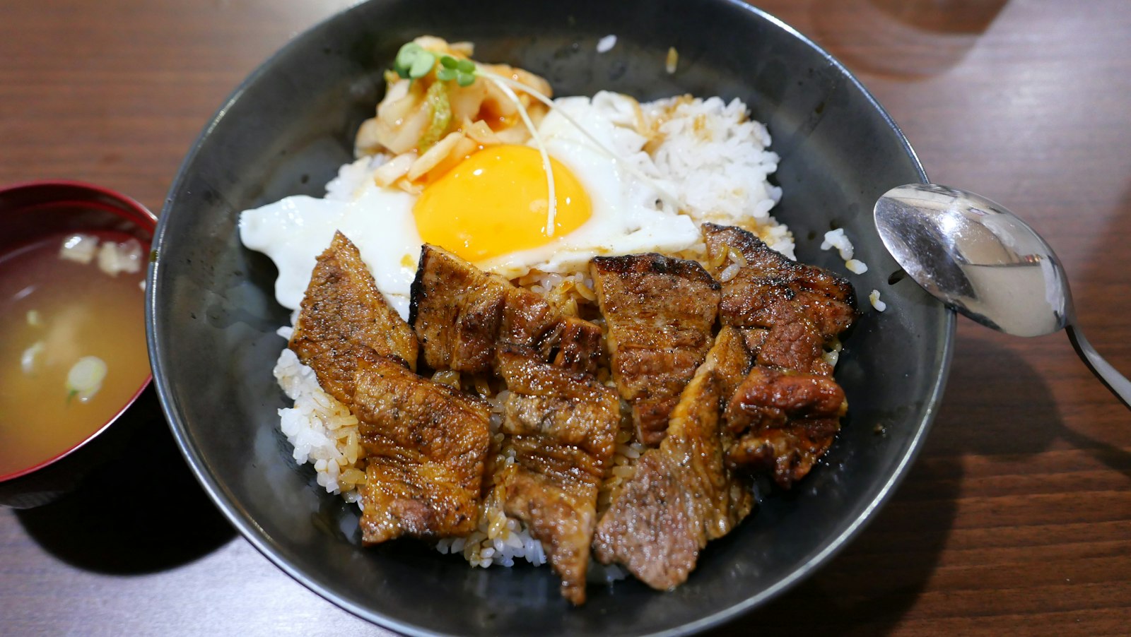Beef and rice bowl with a fried egg