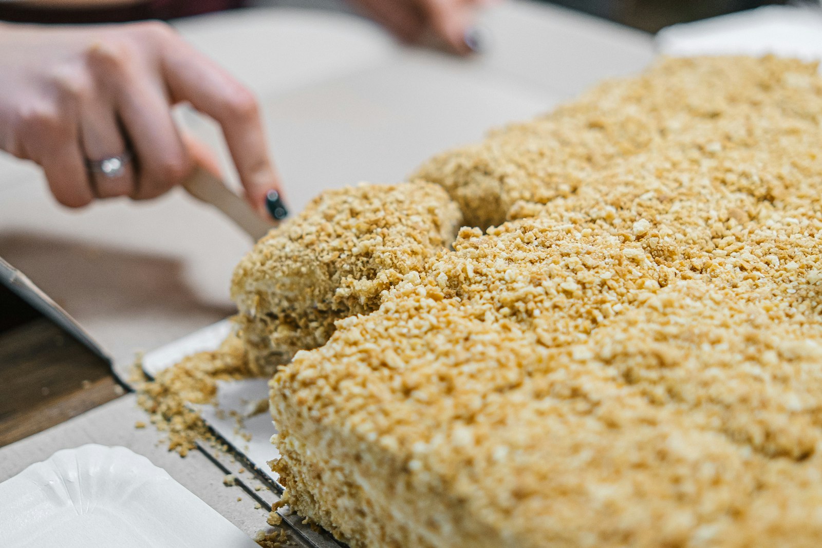 Cutting crispy rice protein bars in a pan