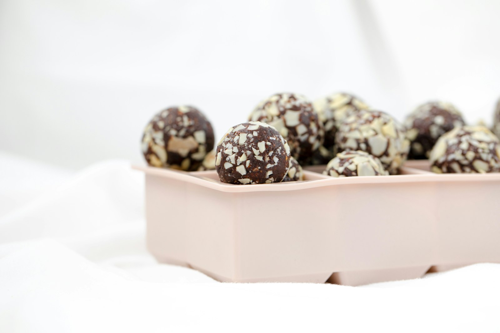 Chocolate energy bites in a pink tray