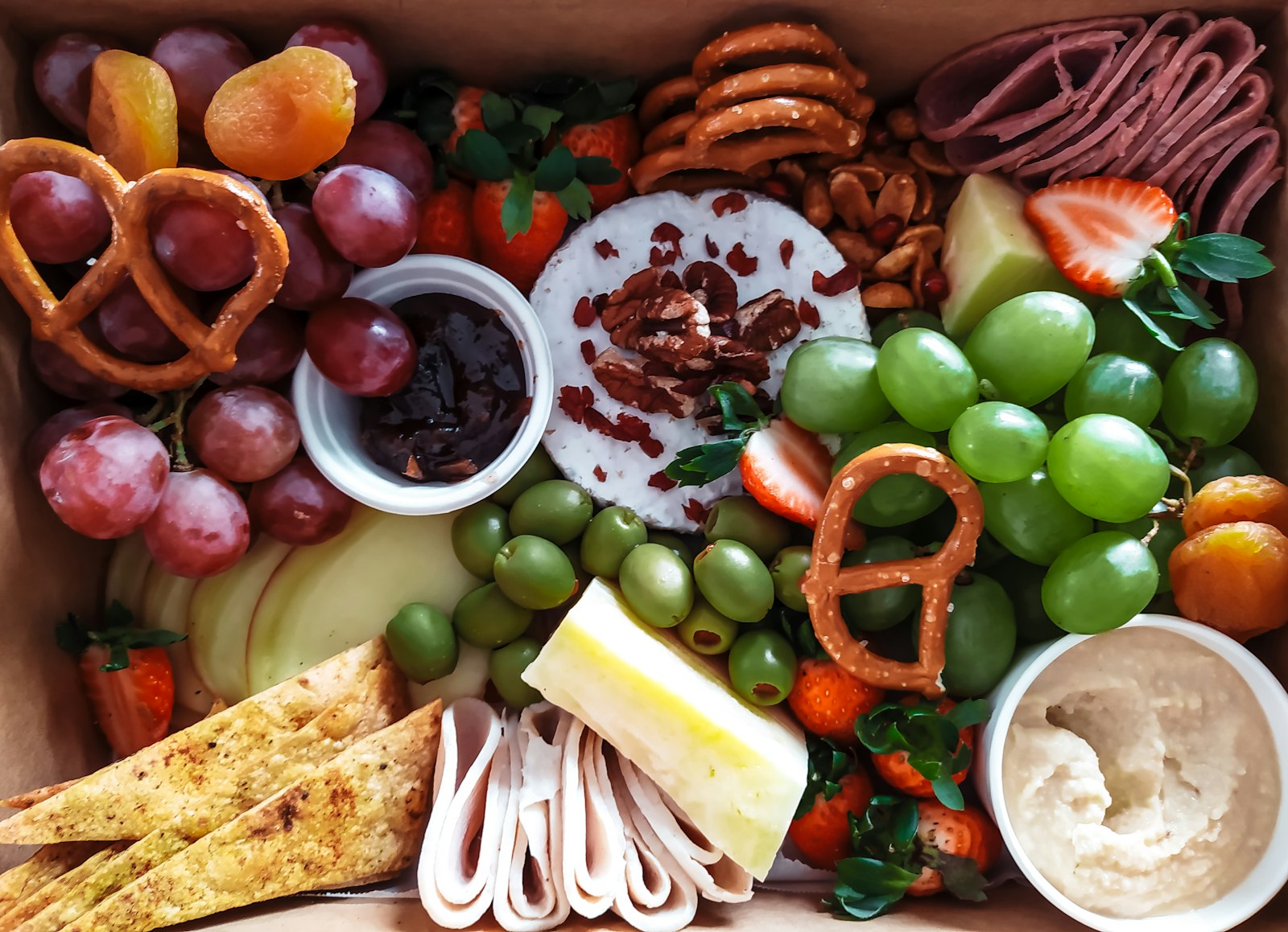 Snack board with fruit, cheese and pretzels