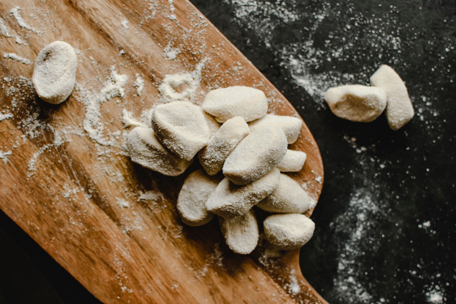Homemade potato dough cut into pillows on a board