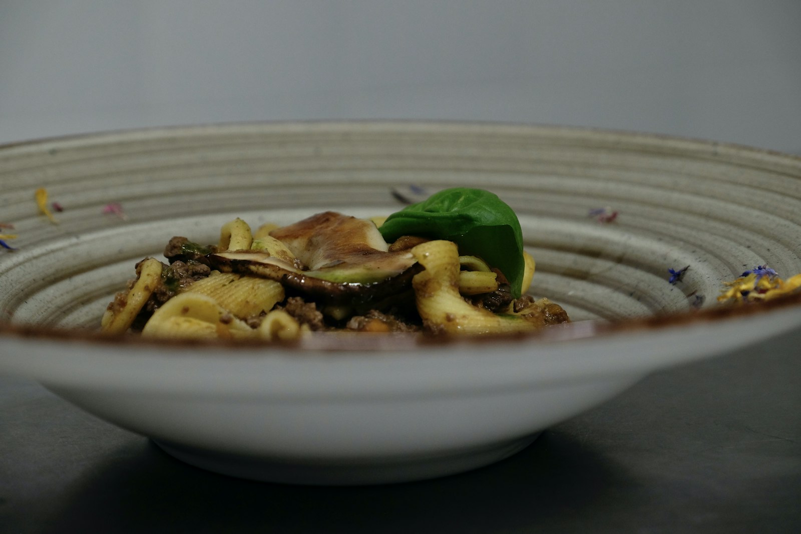 Mushrooms, basil and potato dumplings in a wide bowl