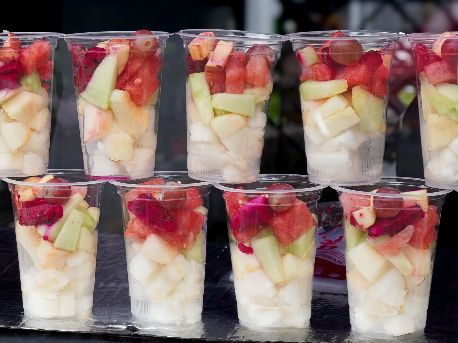 Clear cups of mixed melon and grapes