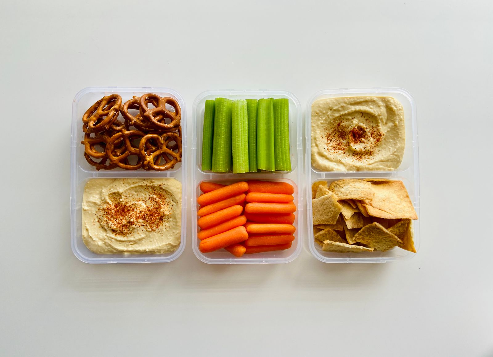 Snack boxes with pretzels, celery, carrots, hummus and crackers