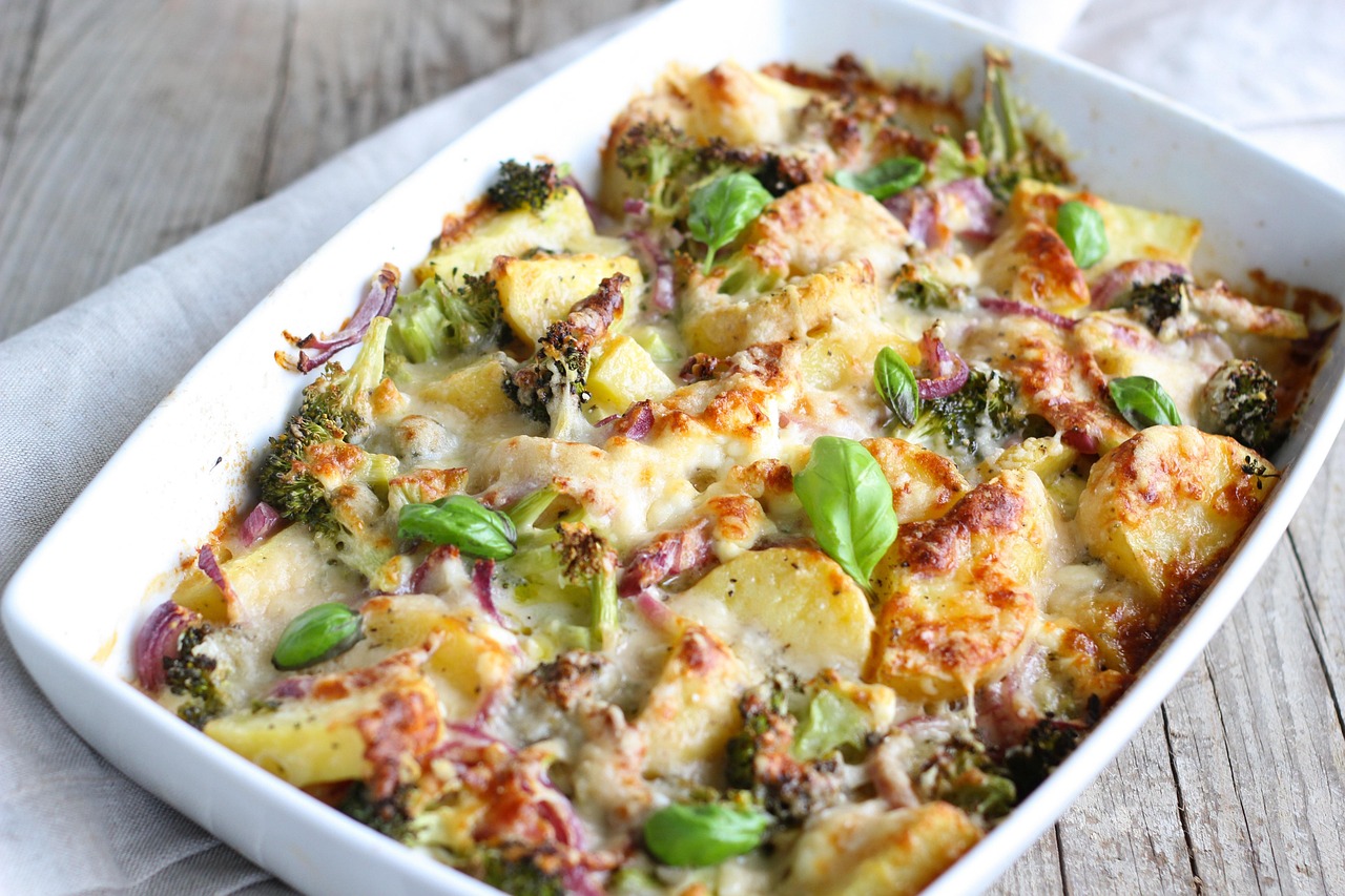 Broccoli cheddar gratin baked in a white dish