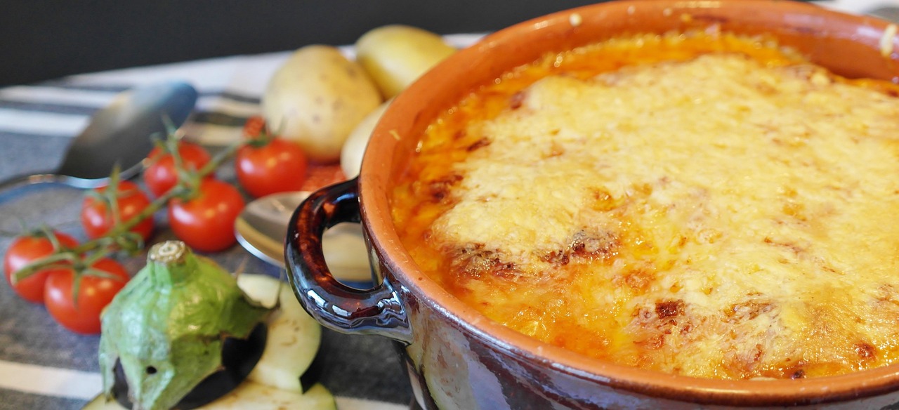 Three-cheese garlic scalloped potatoes in an orange baking dish