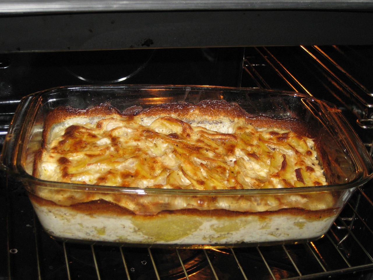 Scalloped potatoes and ham baked in a glass dish