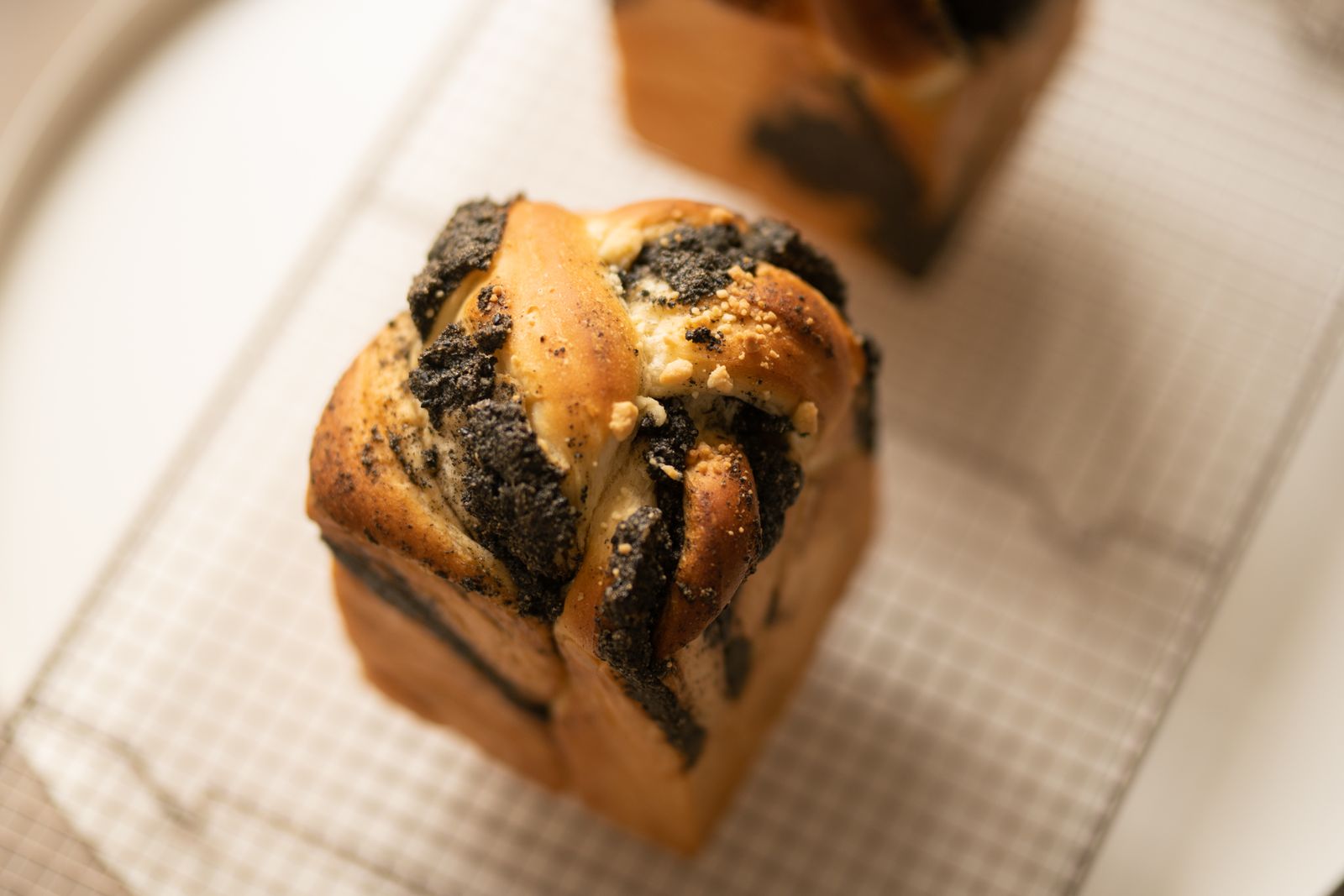 Single chocolate swirl bun cooling on a rack