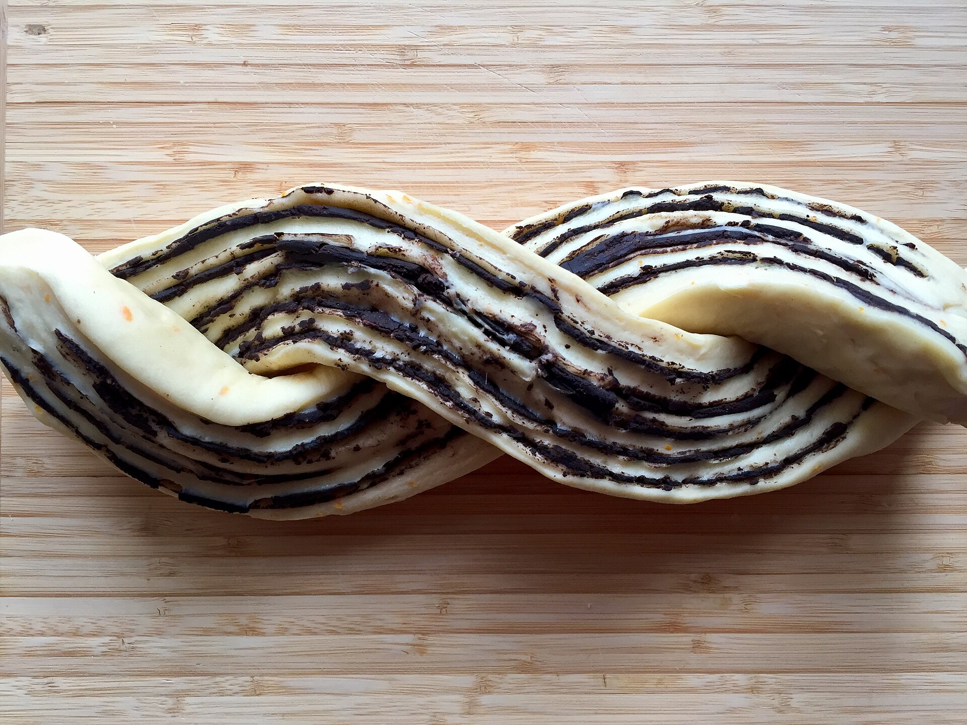 Two strands of chocolate dough twisted together, the key step in babka recipes