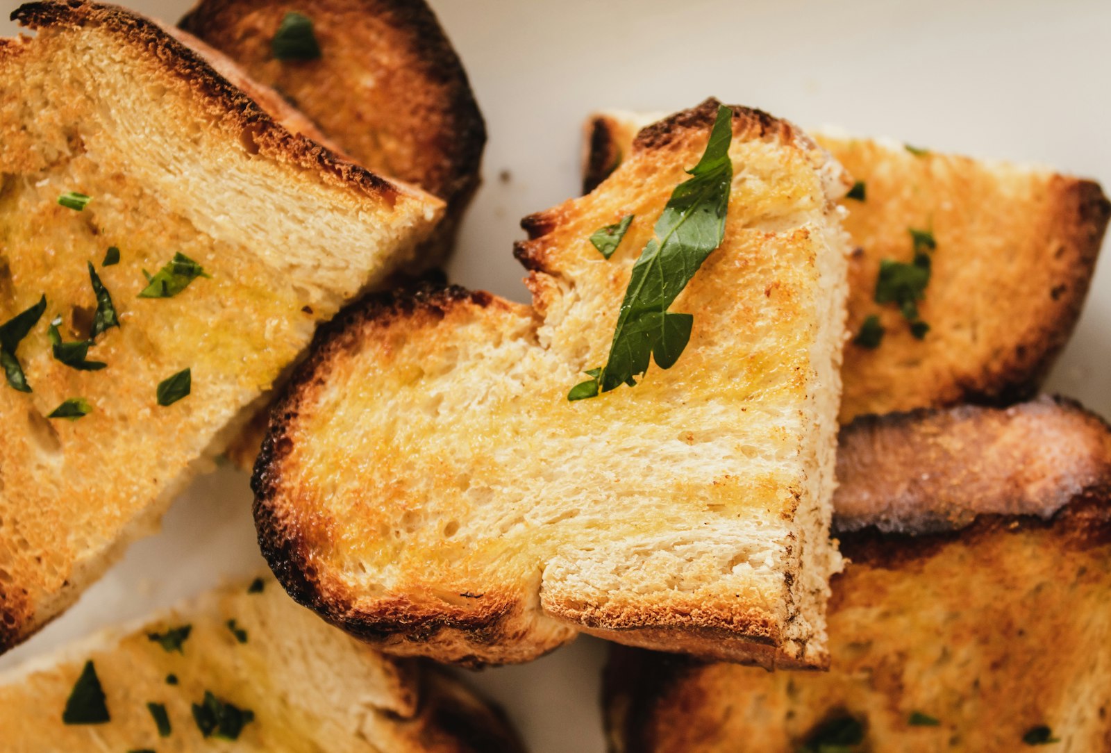 Slices of toasted garlic bread with herbs