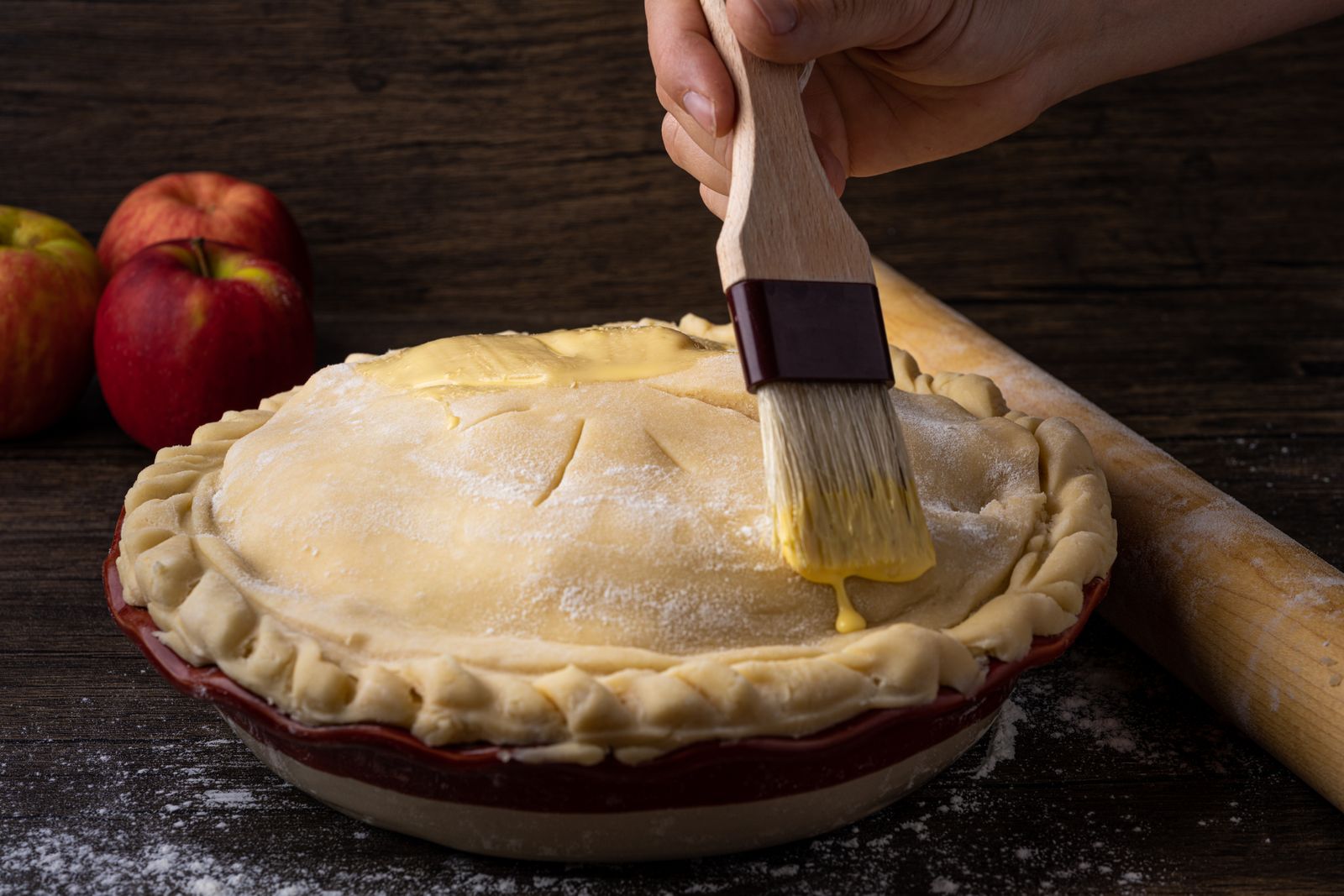 Brushing egg wash on a homemade double crust pie