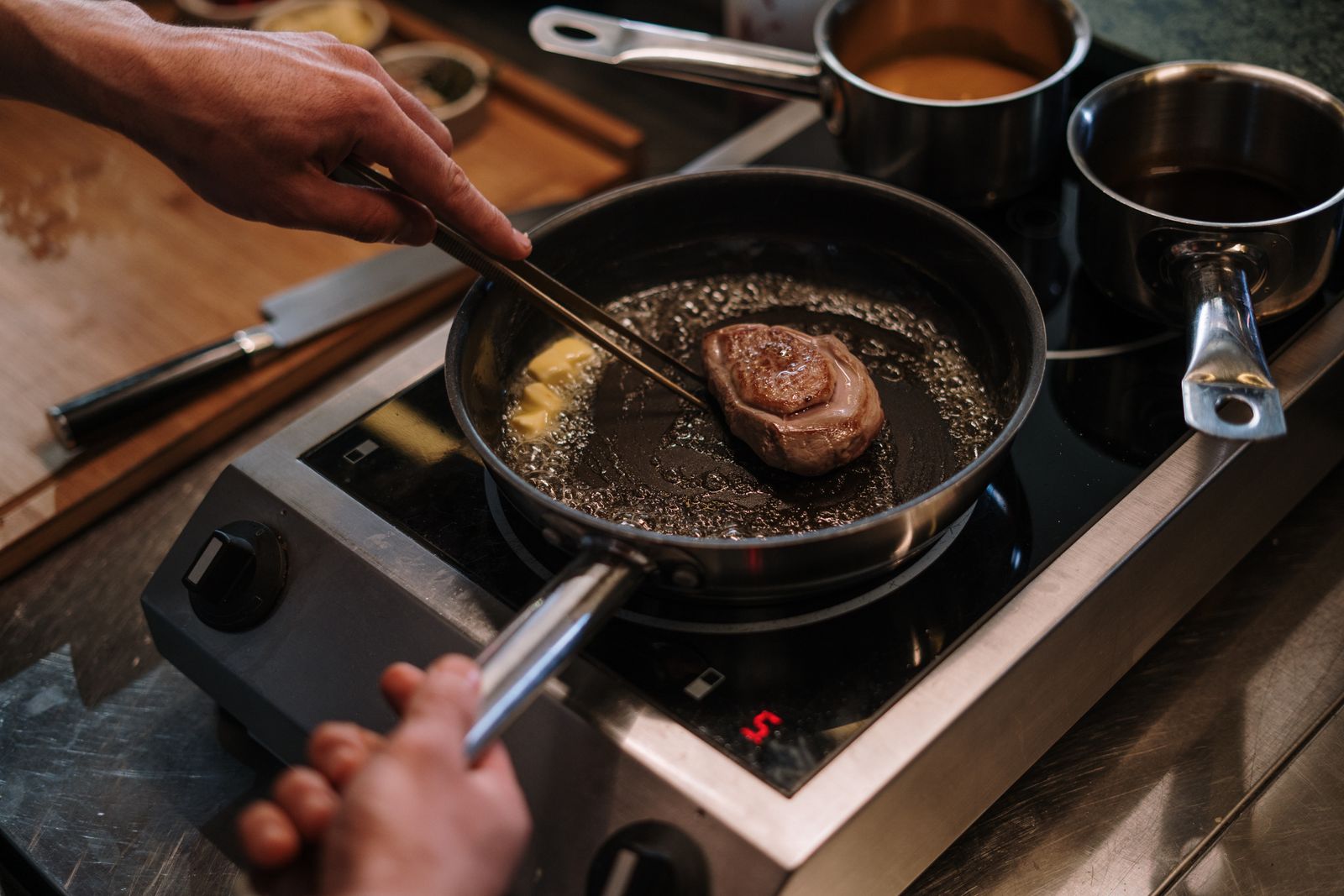 Steak searing in a hot skillet on the stove