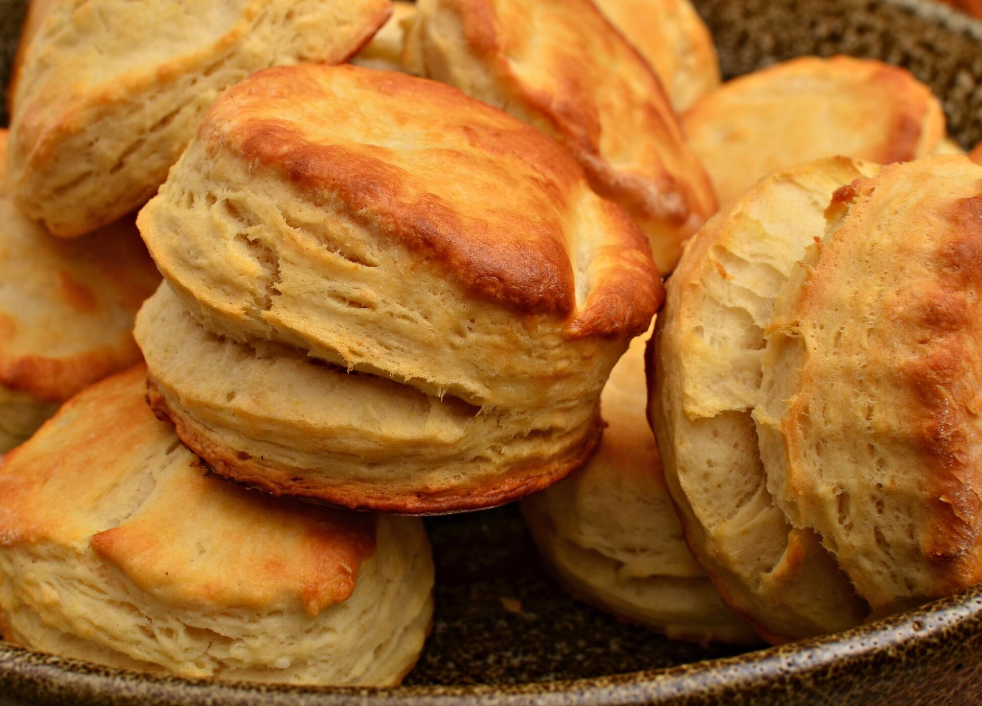 Pile of tall flaky buttermilk biscuits ready to freeze for holiday baking gifts