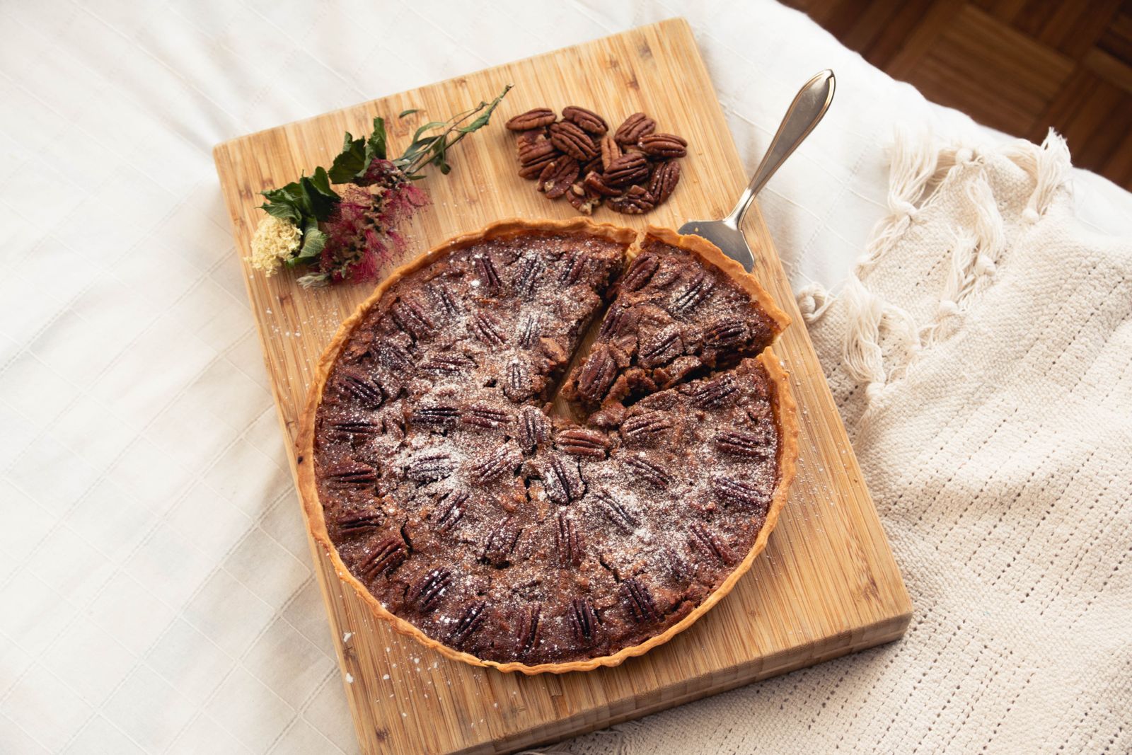 Pecan pie on a wooden board, the same gooey filling used in pecan pie bars