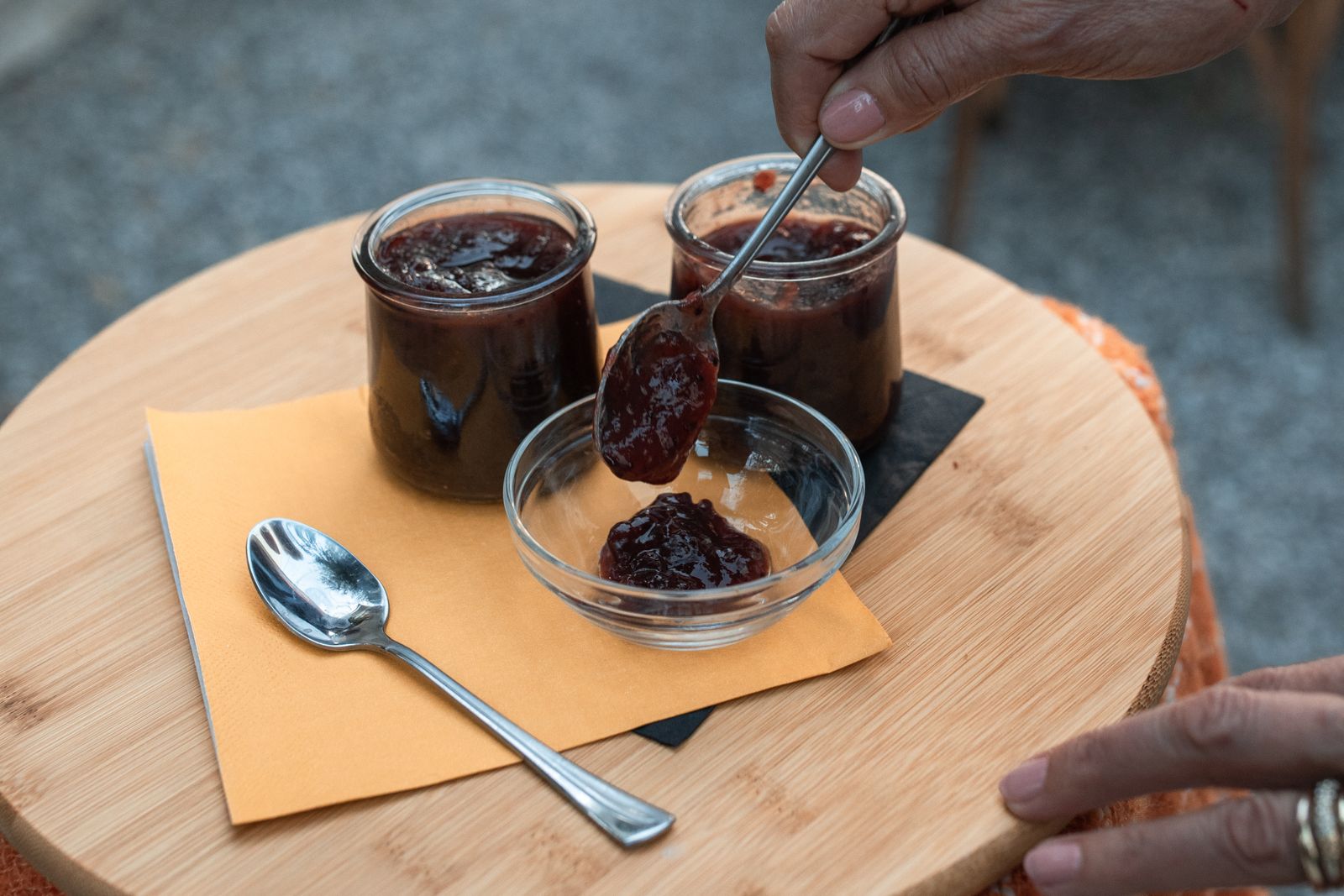 Spooning homemade jelly from glass jars, a sweet partner for holiday baking gifts