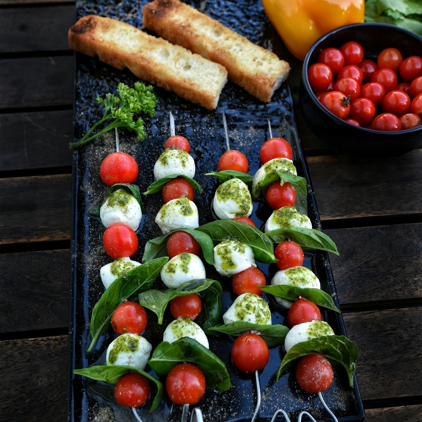 Caprese skewers with tomatoes, mozzarella and basil in rows