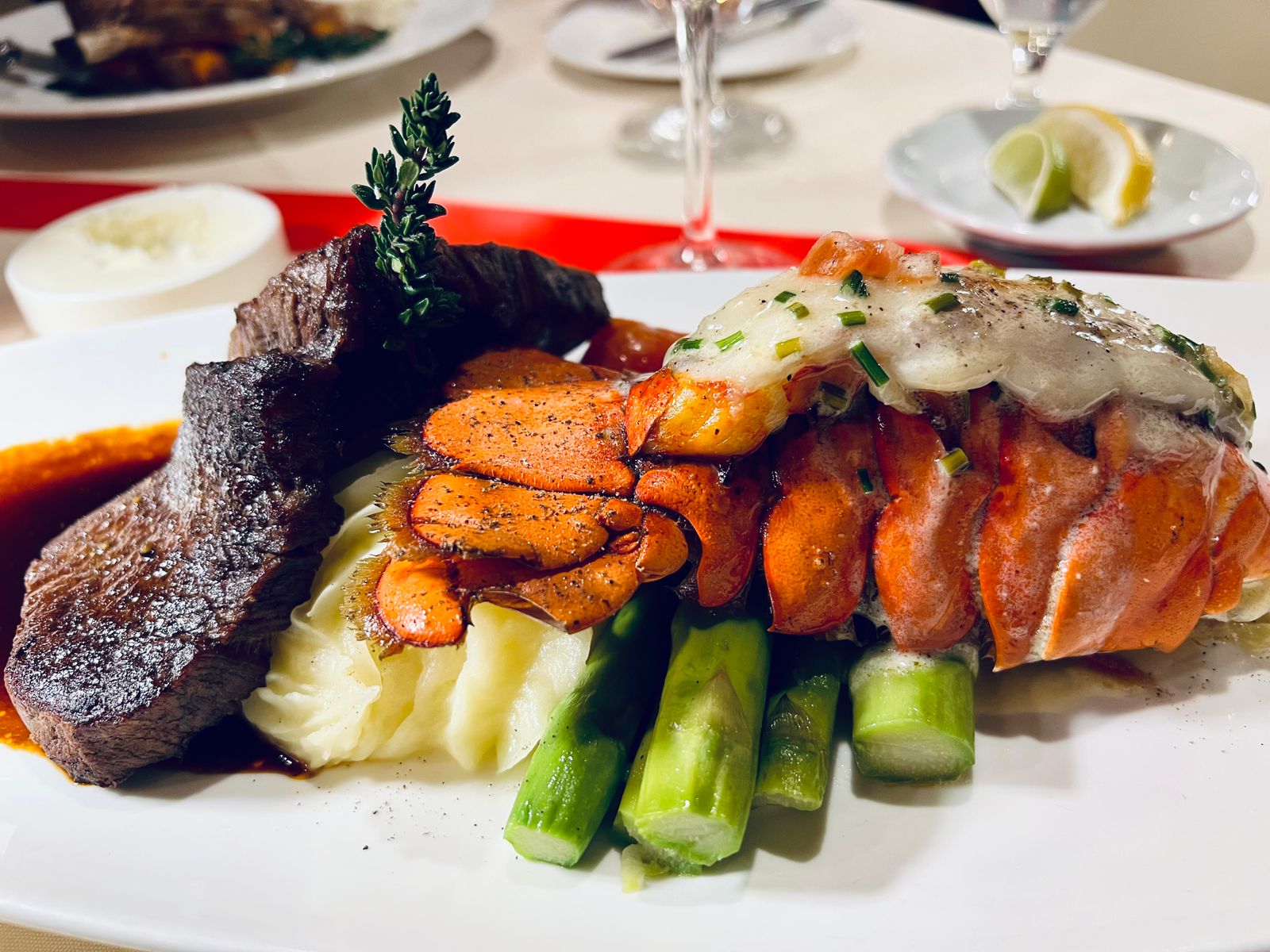 Petite filet and grilled lobster tail with asparagus, a fancy plate from retro Disney recipes