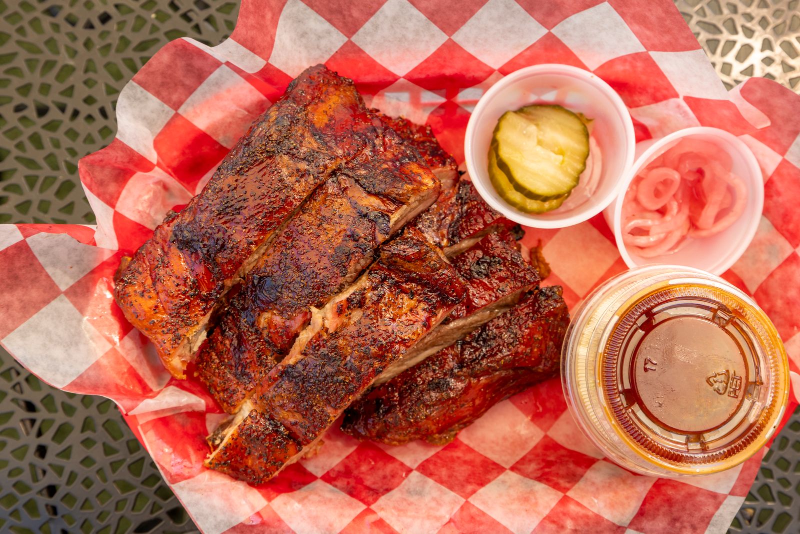 Glazed pork ribs on red checkered paper, inspired by retro Disney recipes from the islands show