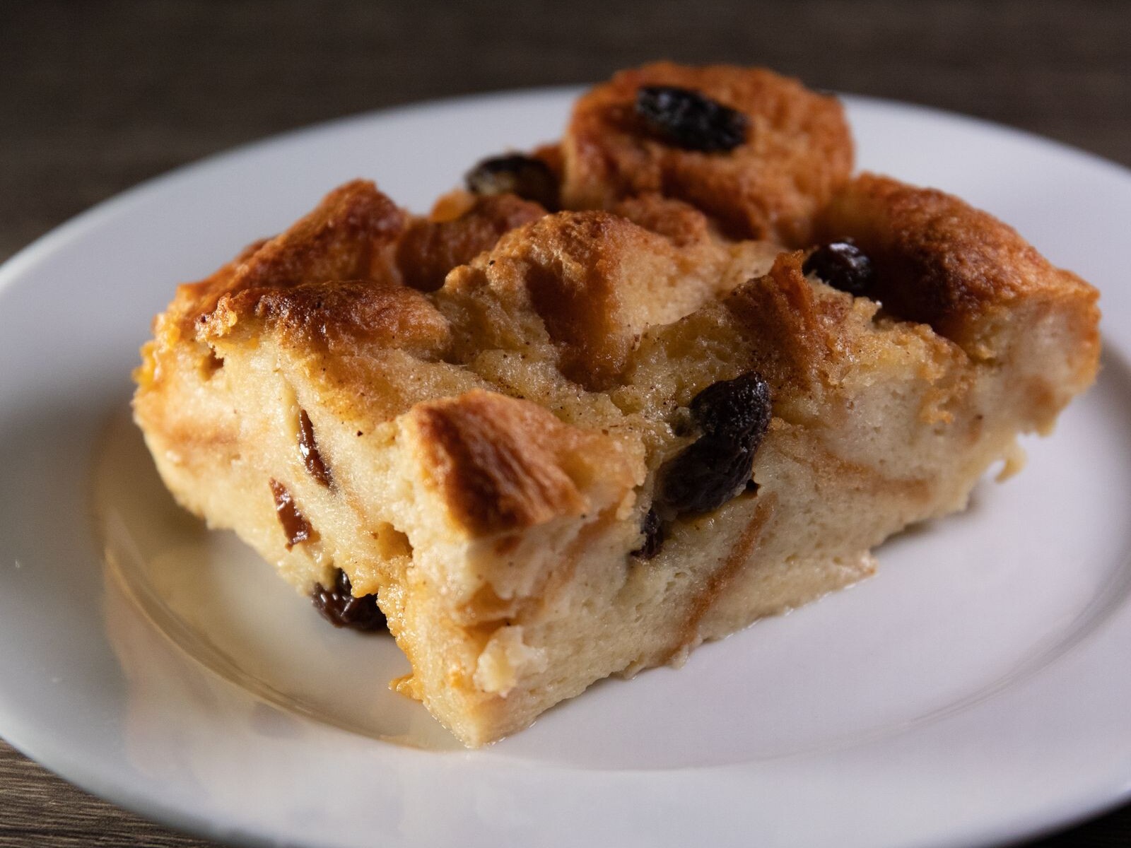 Slice of bread pudding with raisins, a sweet end to Emeril Lagasse recipes