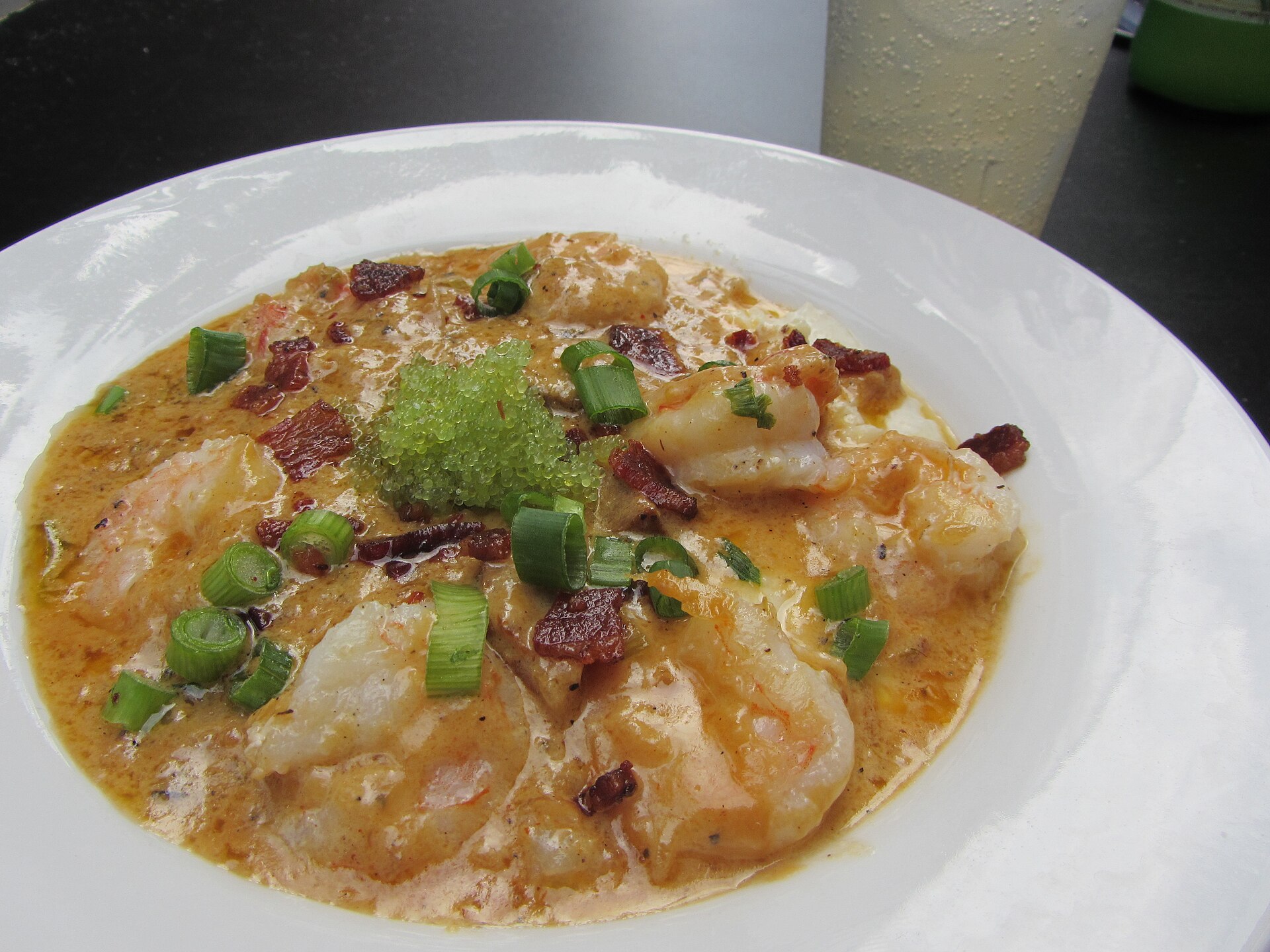 Bowl of shrimp and grits topped with green onions