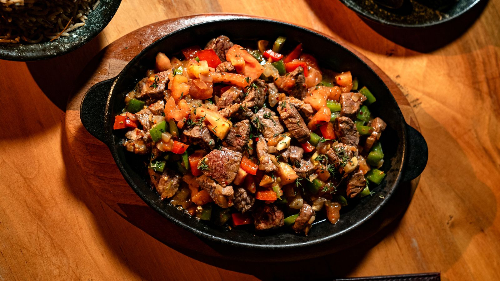 Sizzling beef and peppers in a skillet