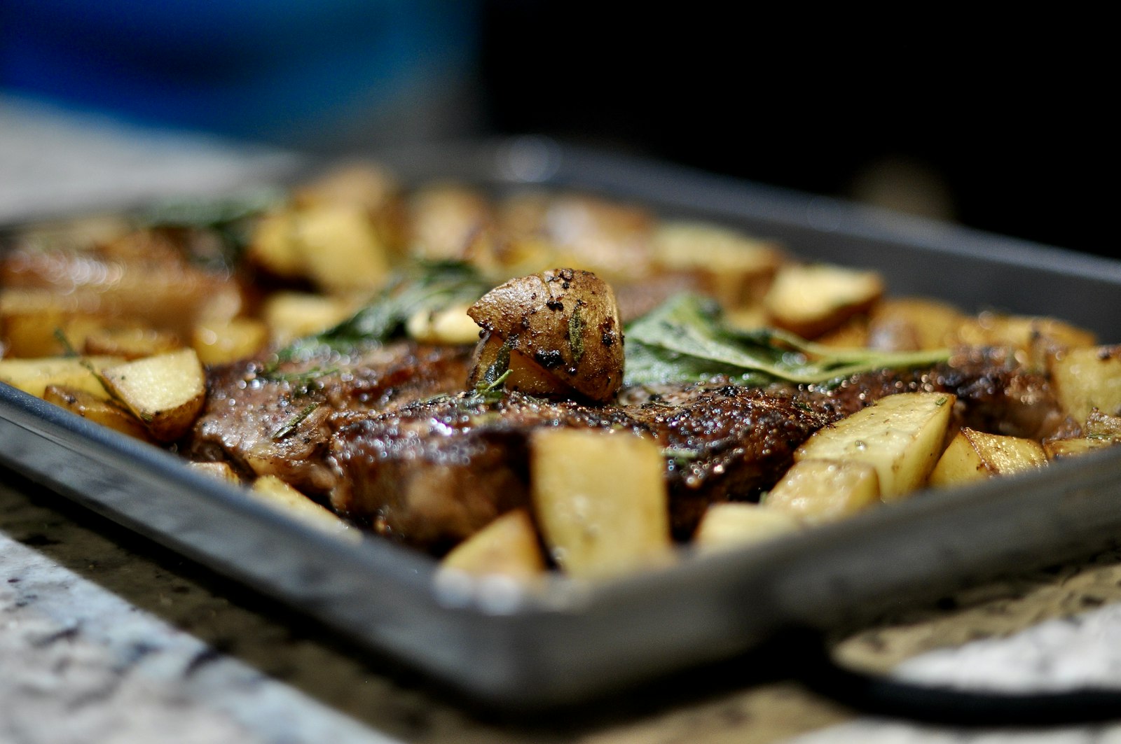 Sheet pan steak and potato dinner with herbs