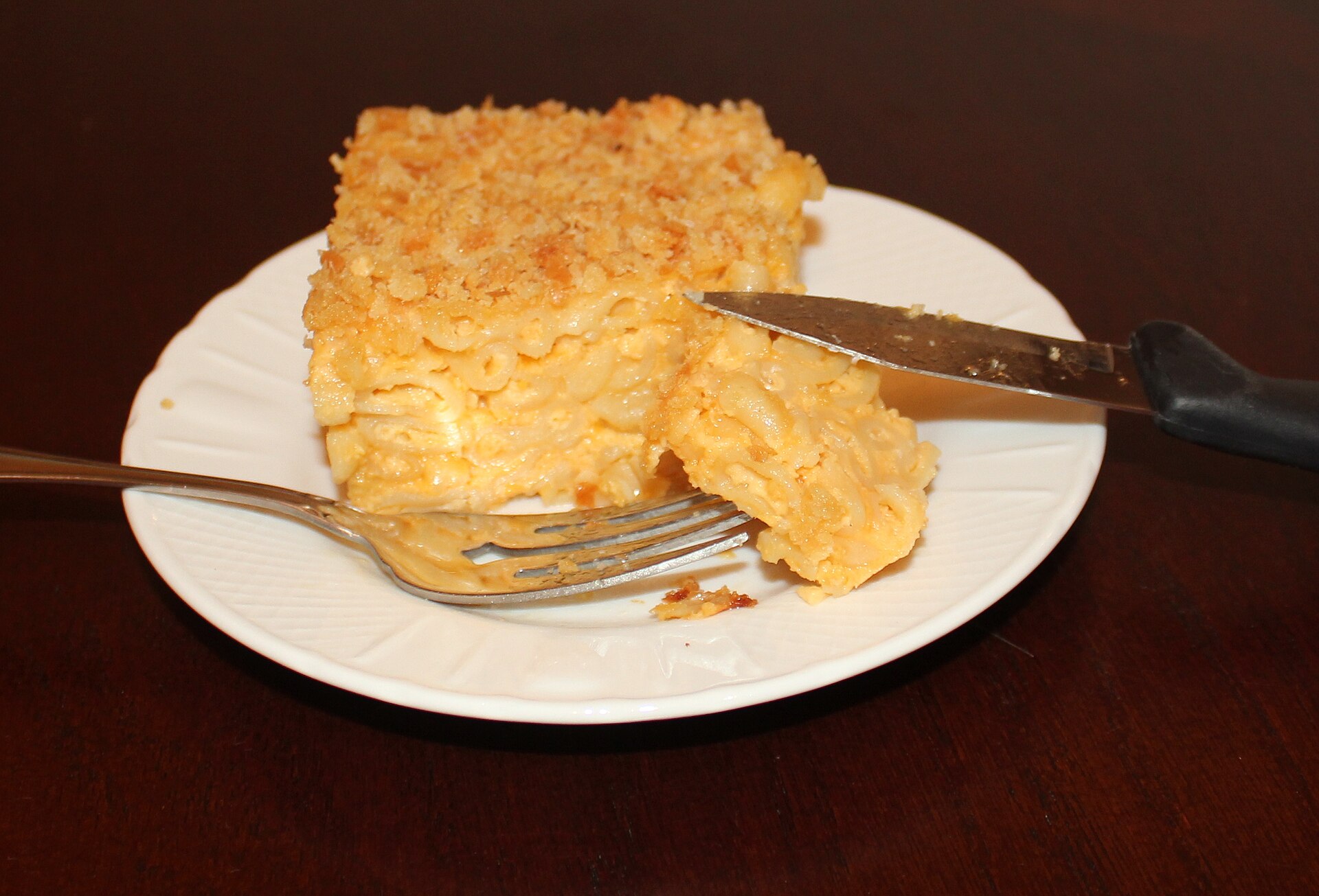 Square of baked macaroni and cheese with a golden top