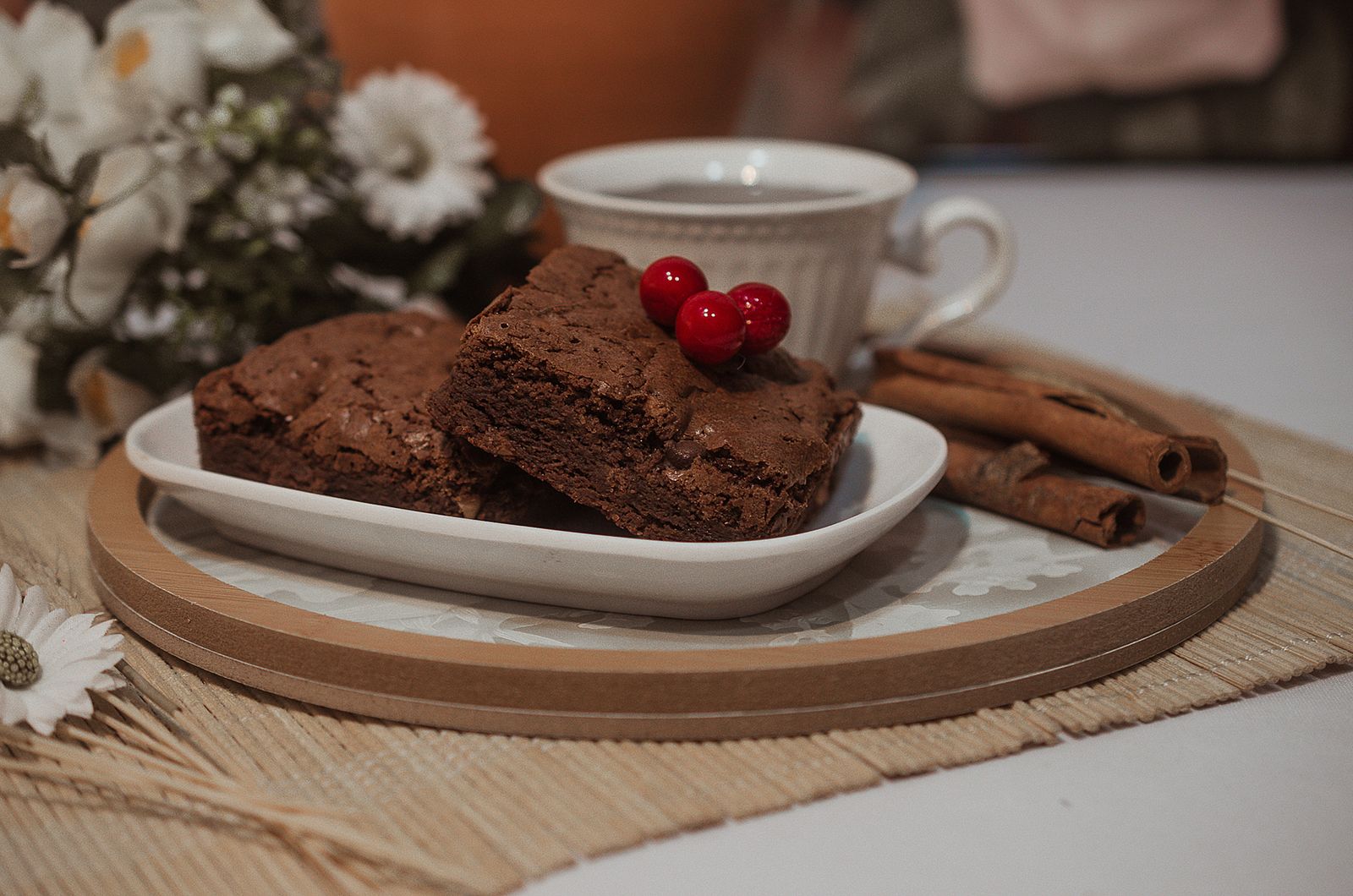 Fudgy brownies on a plate next to a cup of coffee, perfect for Gilmore Girls recipes fans