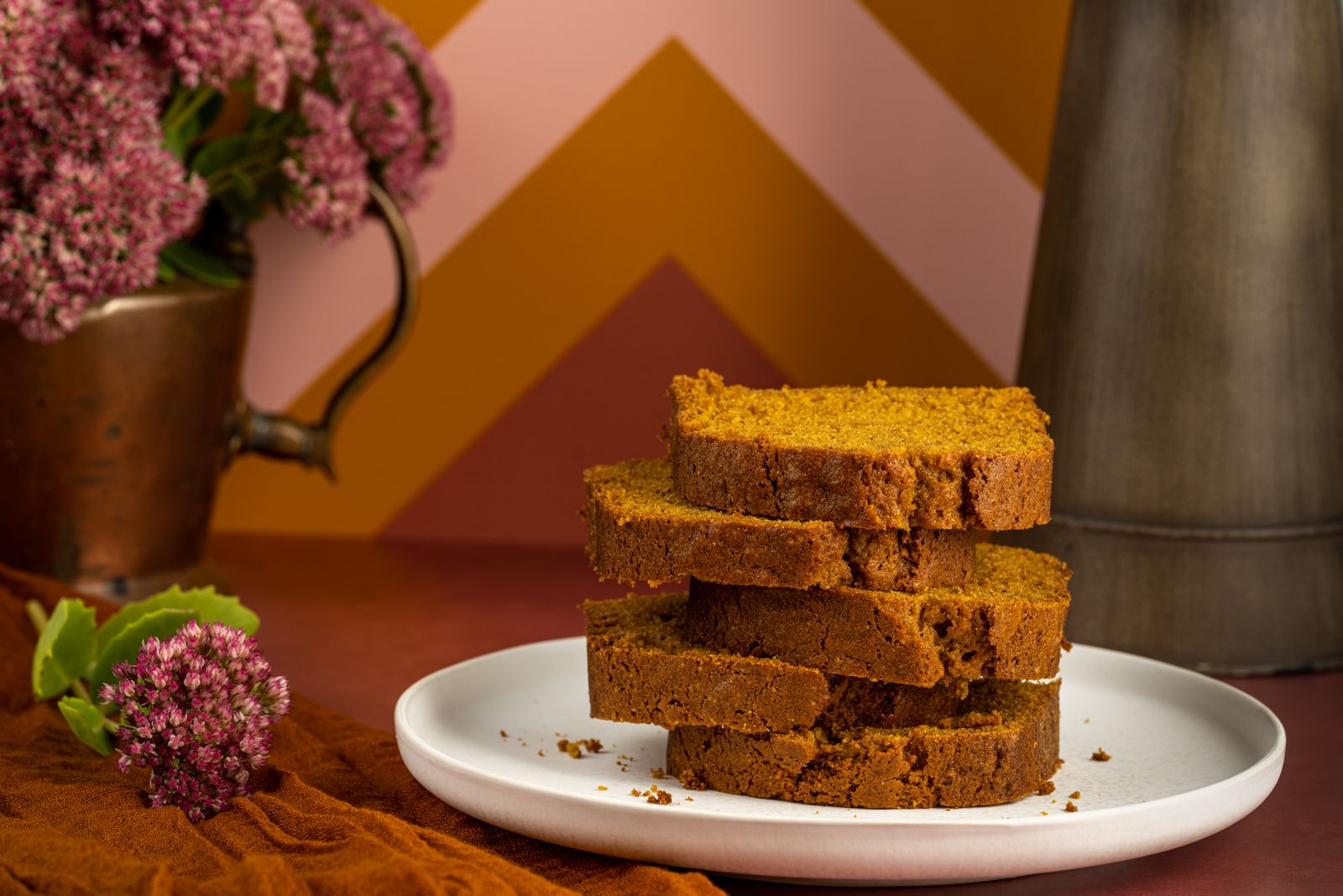 Stack of pumpkin bread slices on a white plate