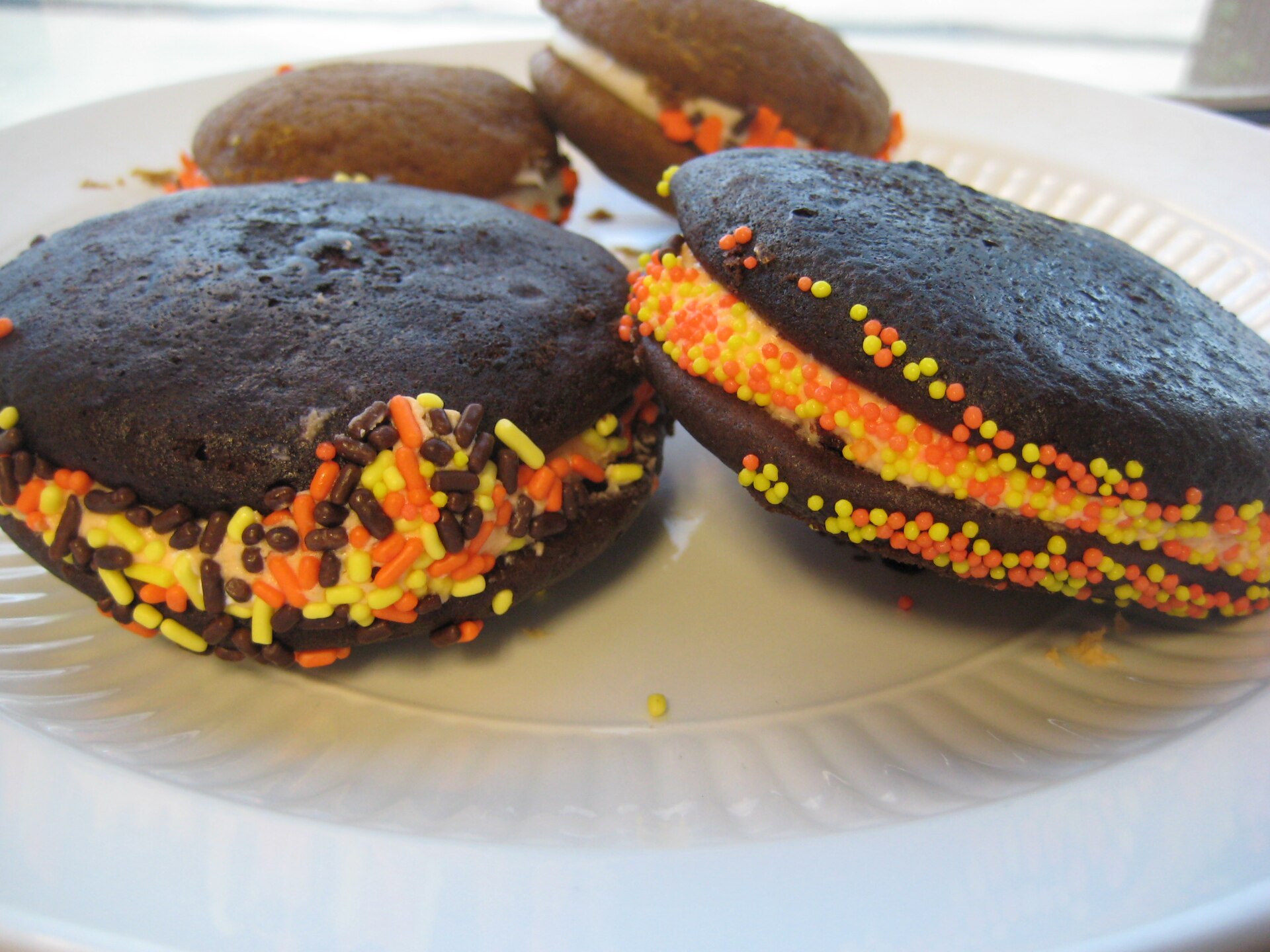 Chocolate whoopie pies with orange and brown sprinkles