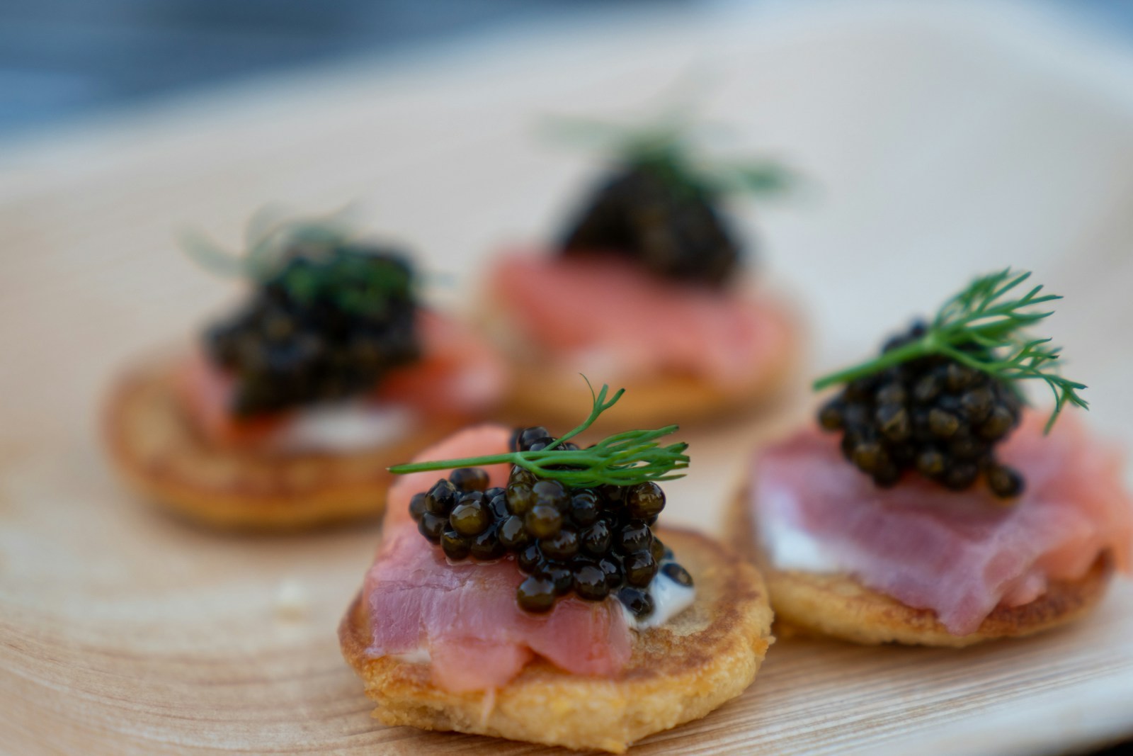 Smoked salmon blini topped with caviar and dill