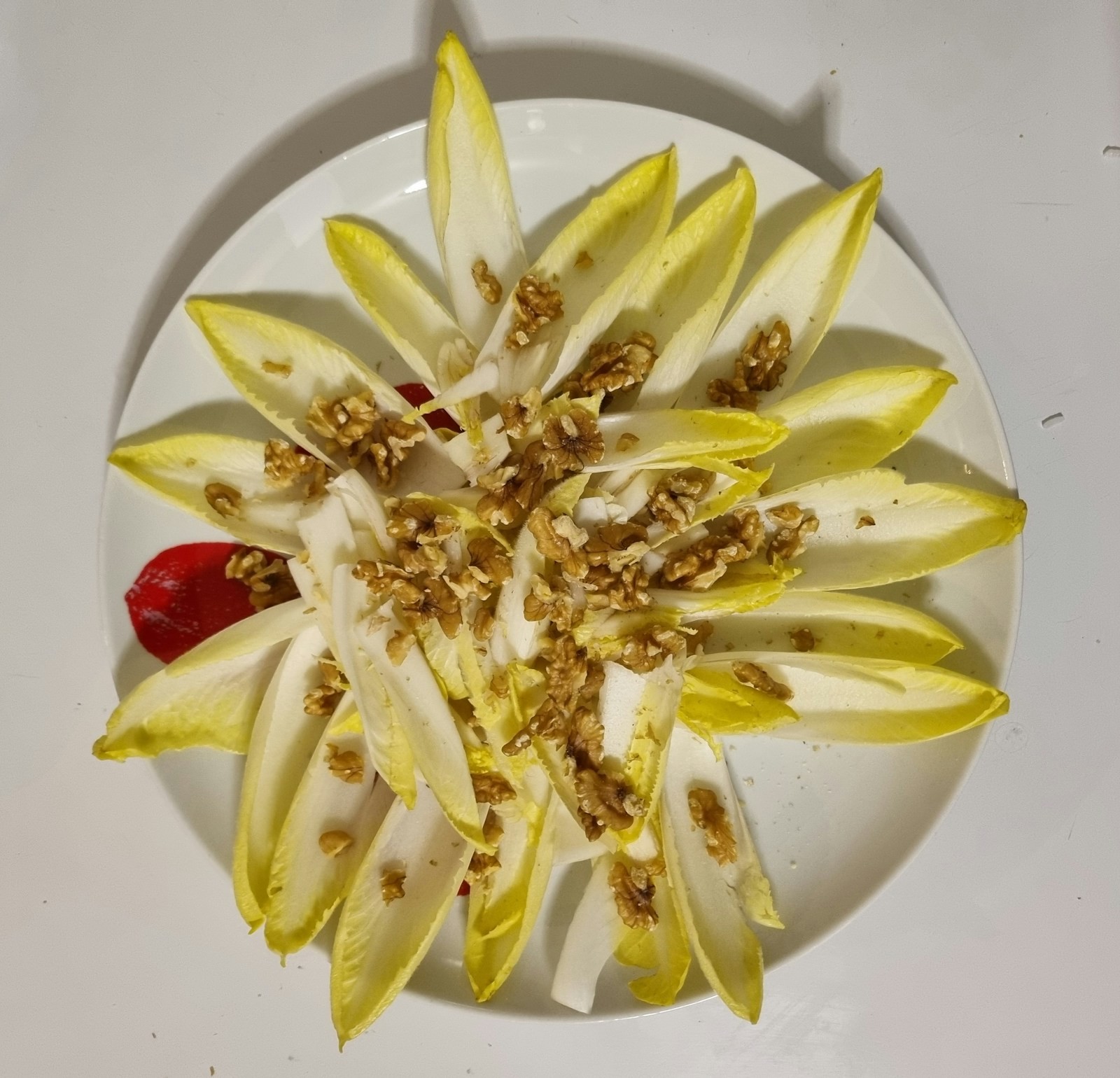 Endive spears with toasted walnuts arranged in a star