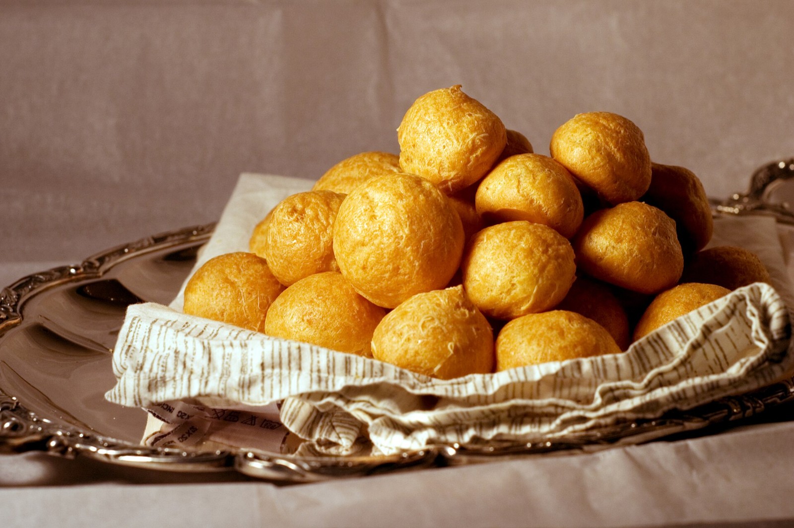 Basket of golden Gruyère cheese gougères for a party
